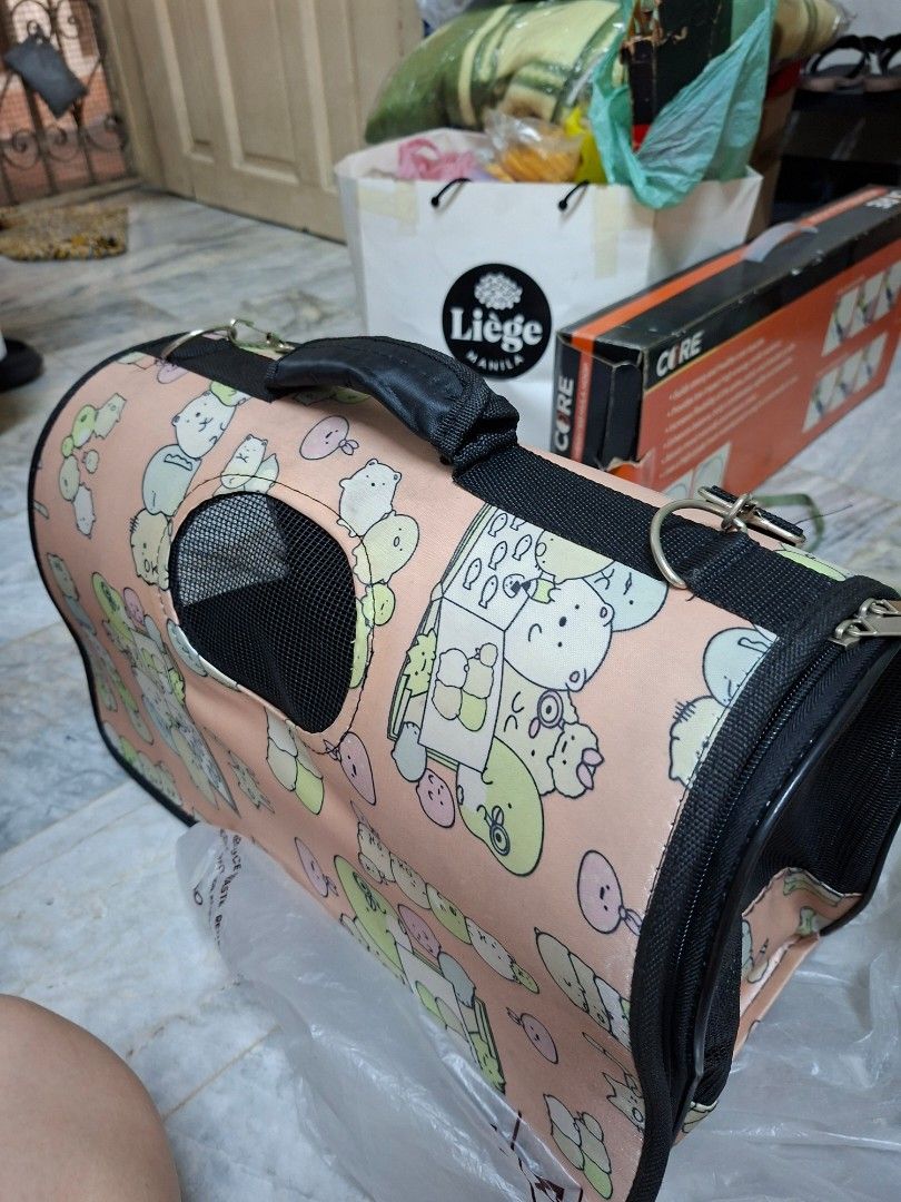 Sumikko Gurashi Pet Carrier Bag (Category: Homes & Other Pet Accessories) located in Manila. Submitted by mochibibi (Listing ID 1428882845, Image 1). Description: Pet carrier bag features a cute Sumikko Gurashi design. It has a mesh window for ventilation and a zipper closure. The bag includes a handle and a shoulder strap for easy carrying. The interior is black, and the exterior has a pink background with Sumikko Gurashi characters..
