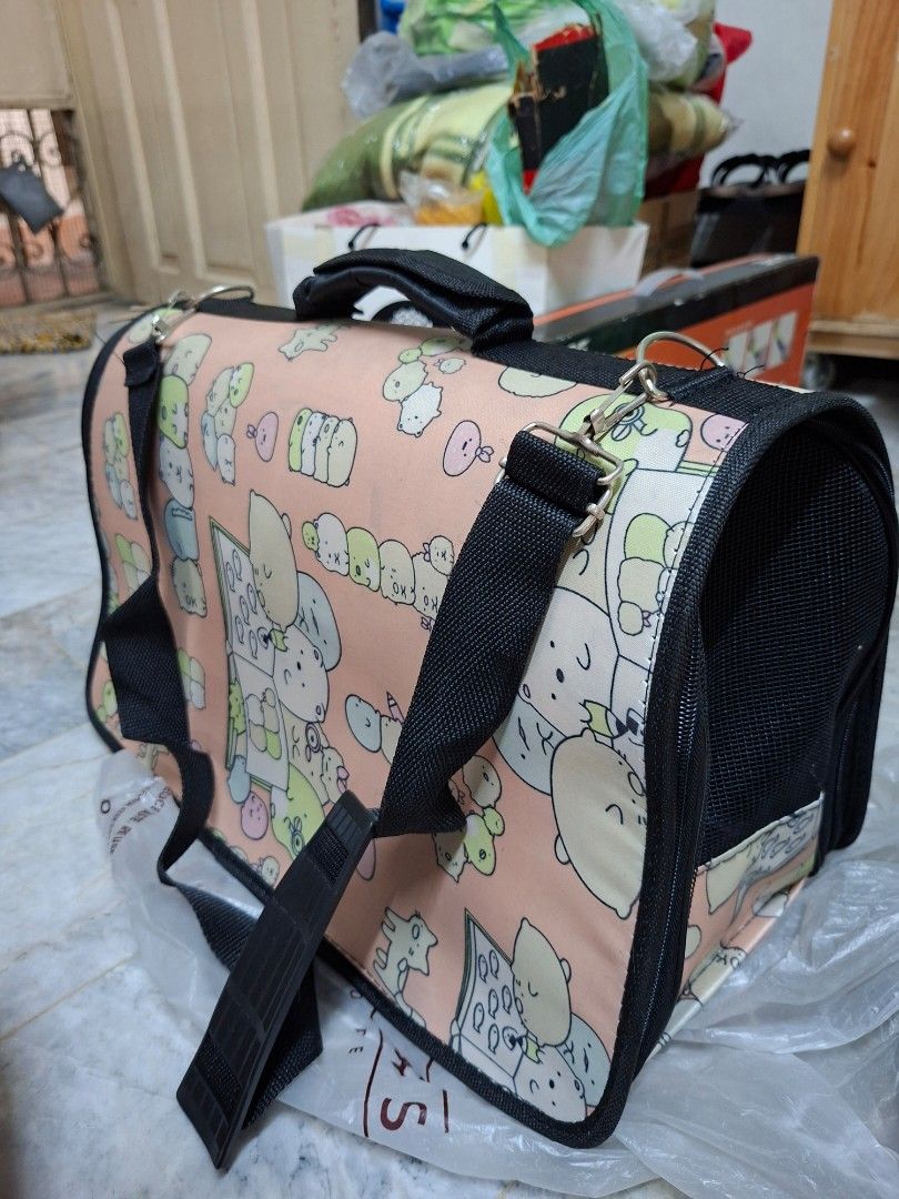 Sumikko Gurashi Pet Carrier Bag (Category: Homes & Other Pet Accessories) located in Manila. Submitted by mochibibi (Listing ID 1428882845, Image 2). Description: Pet carrier bag features a cute Sumikko Gurashi design. It has a mesh window for ventilation and a zipper closure. The bag includes a handle and a shoulder strap for easy carrying. The interior is black, and the exterior has a pink background with Sumikko Gurashi characters..