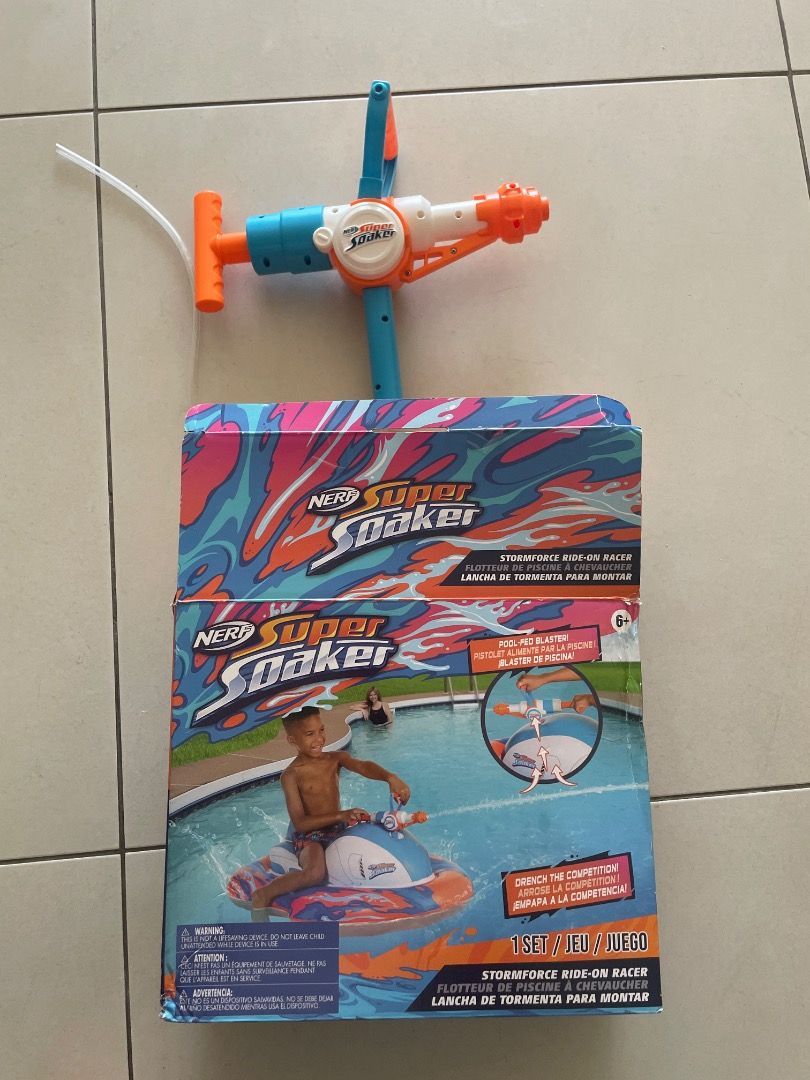Super soaker float (Category: Action & Battle Toys) located in Singapore. Submitted by thevandaho19057 (Listing ID 1428858973, Image 1). Description: Flaring water pistol This product is a Nerf Super Soaker Stormforce Ride-On Racer, an inflatable pool float featuring a mounted water blaster. Features: Includes an inflatable pool float with a built-in blaster, a repair patch, and an instruction manual. Design: Features an easy-to-grip shape design