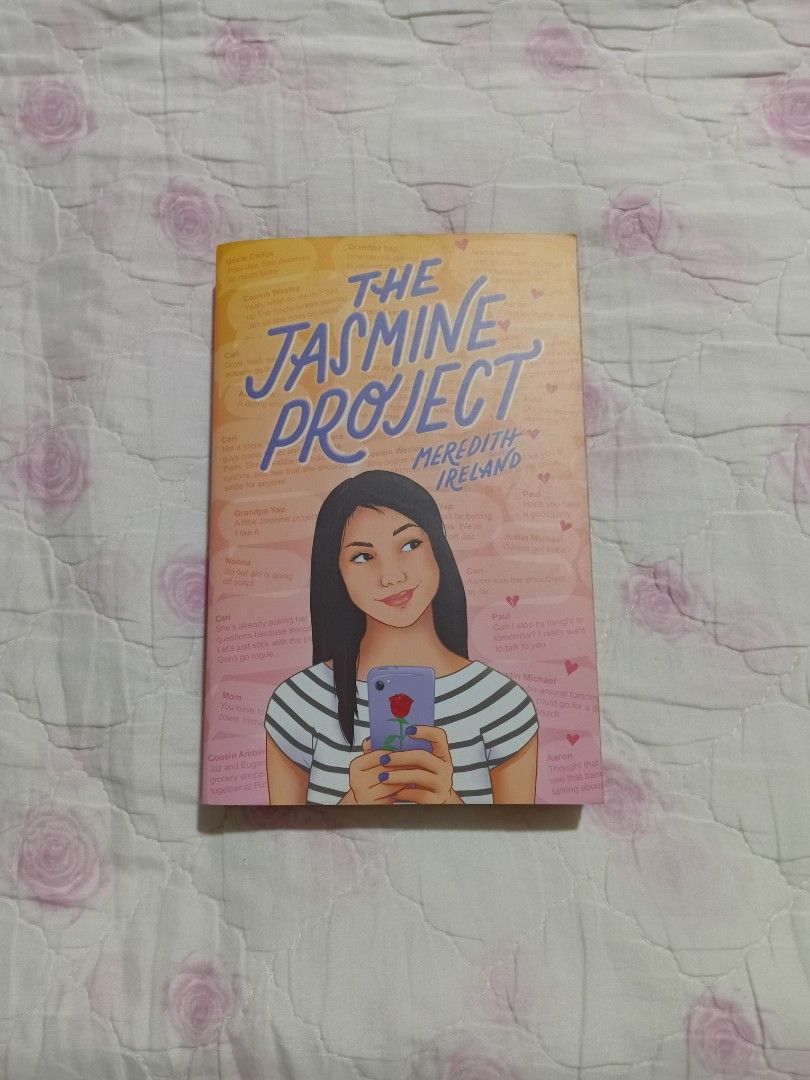 The Jasmine Project by Meredith Ireland Preloved (Category: Storybooks) located in San Juan City. Submitted by bisoussofia (Listing ID 1428906248, Image 1). Description: Copy of "The Jasmine Project" by Meredith Ireland. The book has a pink and orange cover with a girl holding a phone. The spine of the book shows the title and author's name. The back of the book has text..
