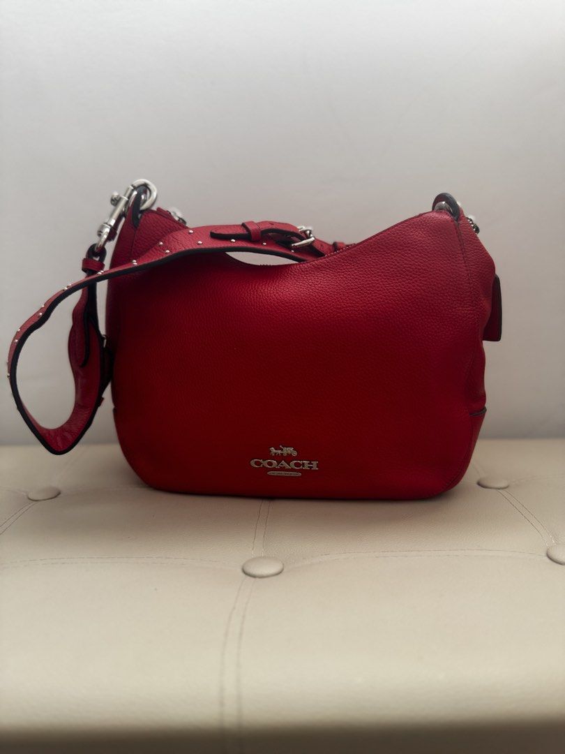 💯 Coach Jess Hobo Shoulder Bag (Category: Shoulder Bags) located in Agno. Submitted by ursecondhand_chic (Listing ID 1429139139, Image 1). Description: Coach Jess Hobo Shoulder Bag This item is a Coach Jess Hobo shoulder bag in Bright Cardinal pebbled leather with silver-tone hardware and rivet details •What you see is what you get •Medium to Semi Large in size •Studs as all intact on the shoulder strap •Honest Issue (Please see last pic): Medyo