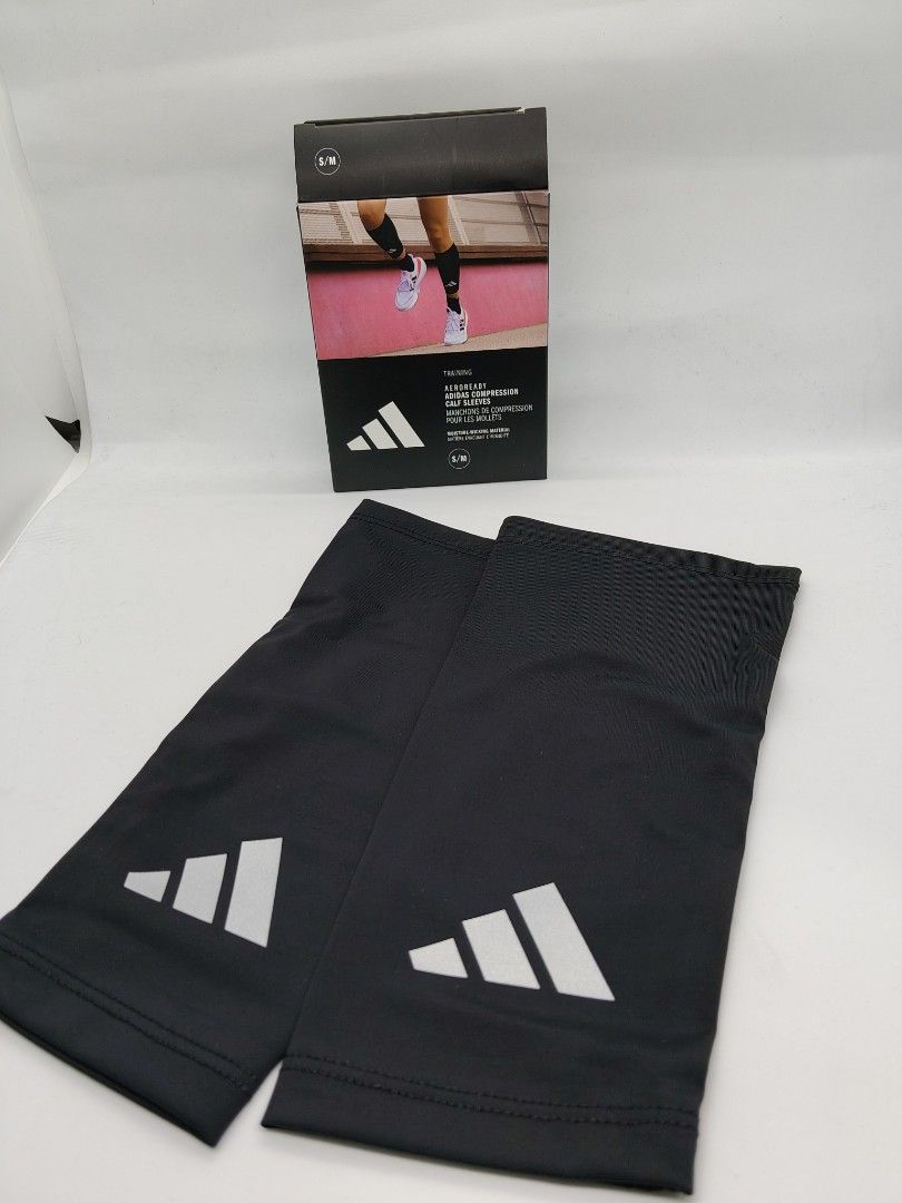 Adidas Compression Calf Sleeves (Category: Activewear) located in Baguio. Submitted by all_uneed2600 (Listing ID 1429002549, Image 1). Description: Adidas compression calf sleeves. Features the Adidas logo. The sleeves are black. The box shows the sleeves being used for running. The box also indicates the size is S/M. Designed for athletes..