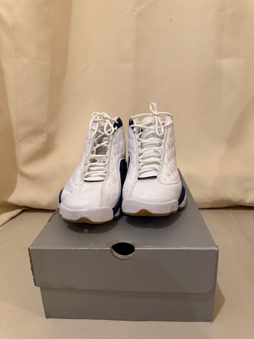 Air Jordan 13 White/Navy Blue (Category: Sneakers) located in Taytay. Submitted by amandagianan (Listing ID 1429141393, Image 3). Description: Air Jordan 13 sneakers in white and navy blue. The shoes have a white leather upper with navy blue accents and a gum sole. The size is US 10.5 The shoes come with the original box. The overall design is a classic basketball shoe..