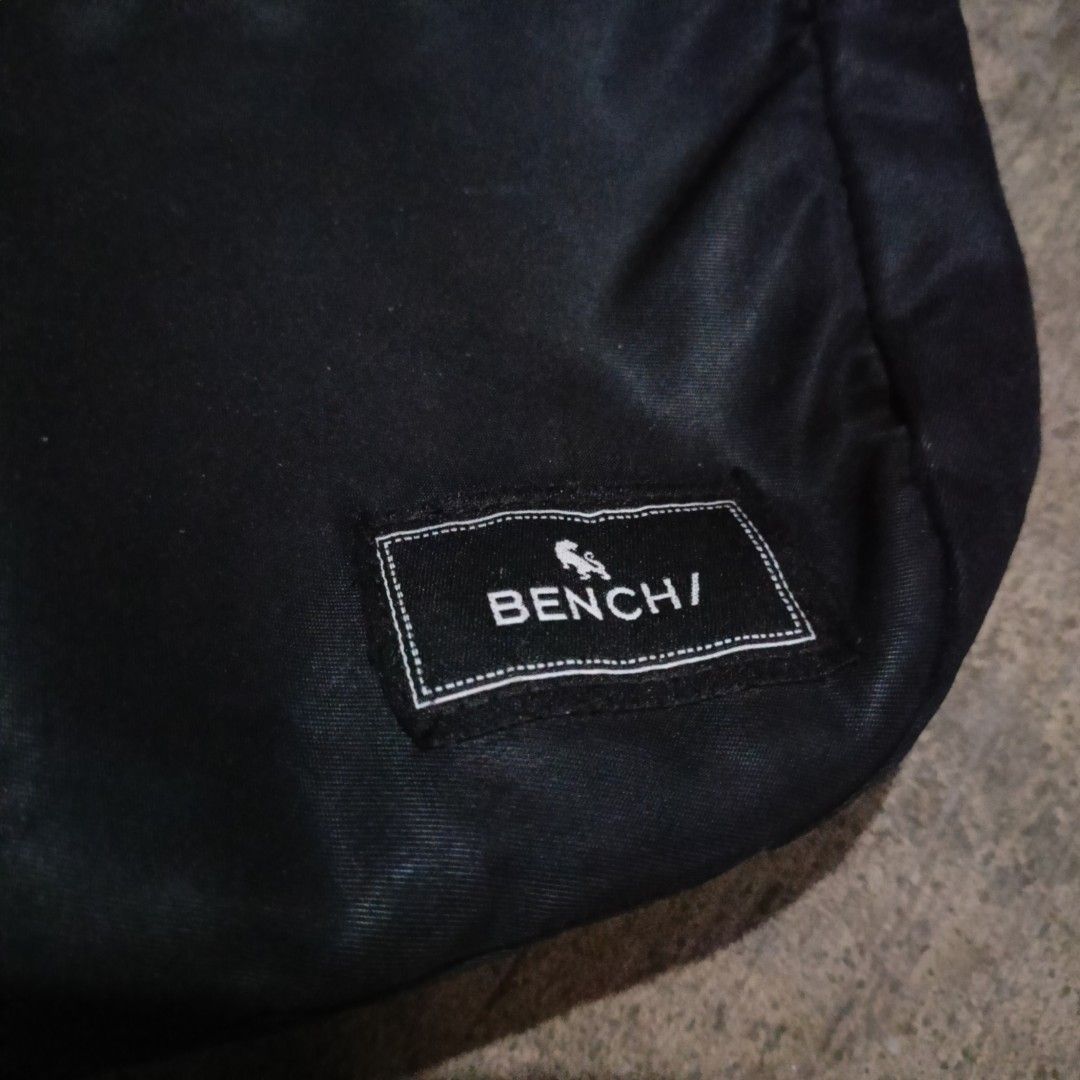 Bench Sling Bag - Black (Category: Sling Bags) located in Penaranda. Submitted by flipmopickmo (Listing ID 1429069196, Image 3). Description: Black Bench sling bag. Features a main compartment with a zipper closure and an adjustable shoulder strap. The interior includes a small tag with the Bench logo and the #loveLocal hashtag. The exterior has a small Bench logo patch. Suitable for everyday use..