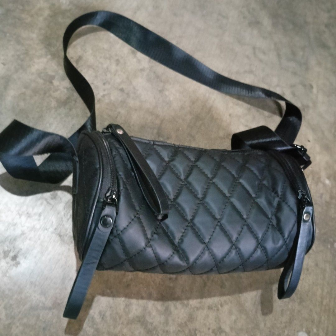 Black Quilted Crossbody Bag (Category: Cross-body Bags) located in Penaranda. Submitted by flipmopickmo (Listing ID 1429059352, Image 2). Description: Stylish black crossbody bag with a quilted design. Features a long adjustable strap for comfortable wear. Includes multiple zippered compartments for secure storage. The bag has a cylindrical shape with a sleek, modern look. Perfect for everyday use or travel..