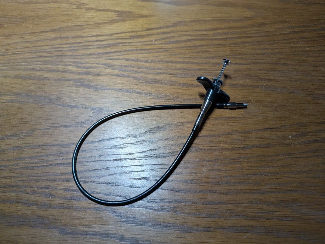 Camera Cable Release (Category: Other Photography Accessories) located in Singapore. Submitted by tuckomatic (Listing ID 1429147130, Image 1). Description: button to screw length is approximately 40cm. mechanical cable release for a camera. The cable is flexible and the release mechanism looks to be working well. Perfect for long exposures or reducing camera shake..