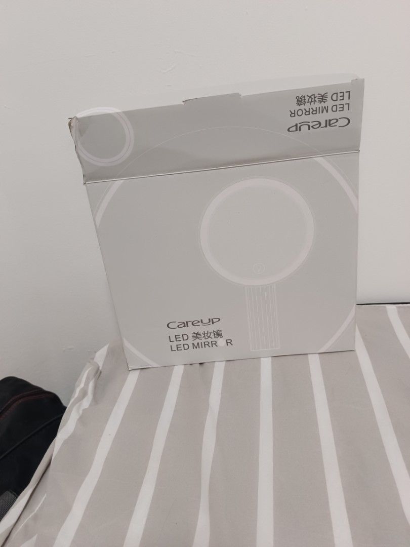 CareUp LED Mirror - Rechargeable (Category: Mirrors) located in Singapore. Submitted by biiboobiiboo (Listing ID 1429037701, Image 3). Description: CareUp LED mirror, perfect for makeup or grooming. Features a built-in LED light and is rechargeable via micro-USB. Got three mode light. Comes with original box. The mirror is in excellent condition..