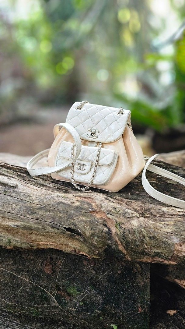 Chanel Caviar Duma Mini Backpack (Category: Luxury Bags & Wallets) located in Kibawe. Submitted by Thrift_ni_Babac (Listing ID 1429086127, Image 1). Description: Chanel Mini Duma Bagpack White quilted mini backpack with a flap closure. It features a silver-tone chain strap and a Chanel logo on the front. The interior has a small pocket with a Chanel logo tag and Microchip The bag is made in France. The bag has some signs of wear, including some d