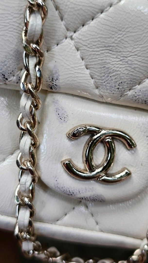 Chanel Caviar Duma Mini Backpack (Category: Luxury Bags & Wallets) located in Kibawe. Submitted by Thrift_ni_Babac (Listing ID 1429086127, Image 3). Description: Chanel Mini Duma Bagpack White quilted mini backpack with a flap closure. It features a silver-tone chain strap and a Chanel logo on the front. The interior has a small pocket with a Chanel logo tag and Microchip The bag is made in France. The bag has some signs of wear, including some d