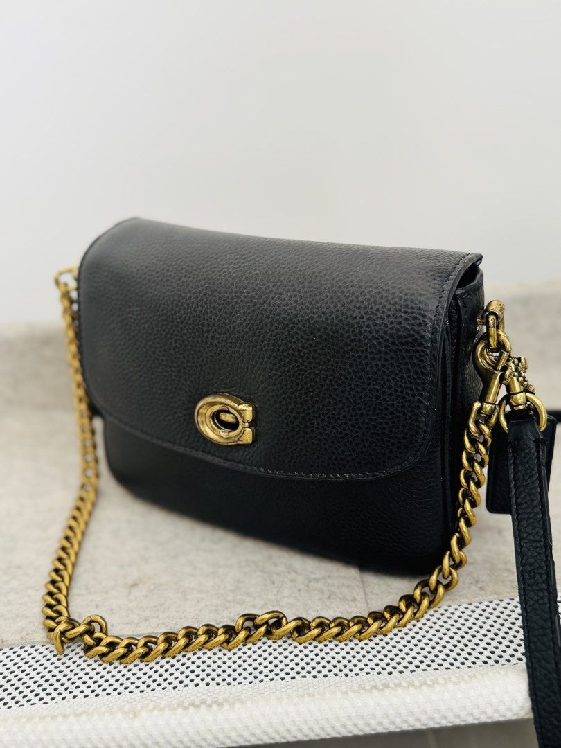Coach Cassie Crossbody 19 (Category: Cross-body Bags) located in Cavite. Submitted by chaidc (Listing ID 1429049625, Image 2). Description: Brand: Coach Model: Cassie Crossbody 19 Color: Black with gold hardware Material: Refined pebble leather Details: • Turn-lock closure • Detachable top handle • Detachable long strap (crossbody) • Gold chain strap included • Multiple compartments (very practical) Inclusions: dust bag / Gold chain, 2 detachable