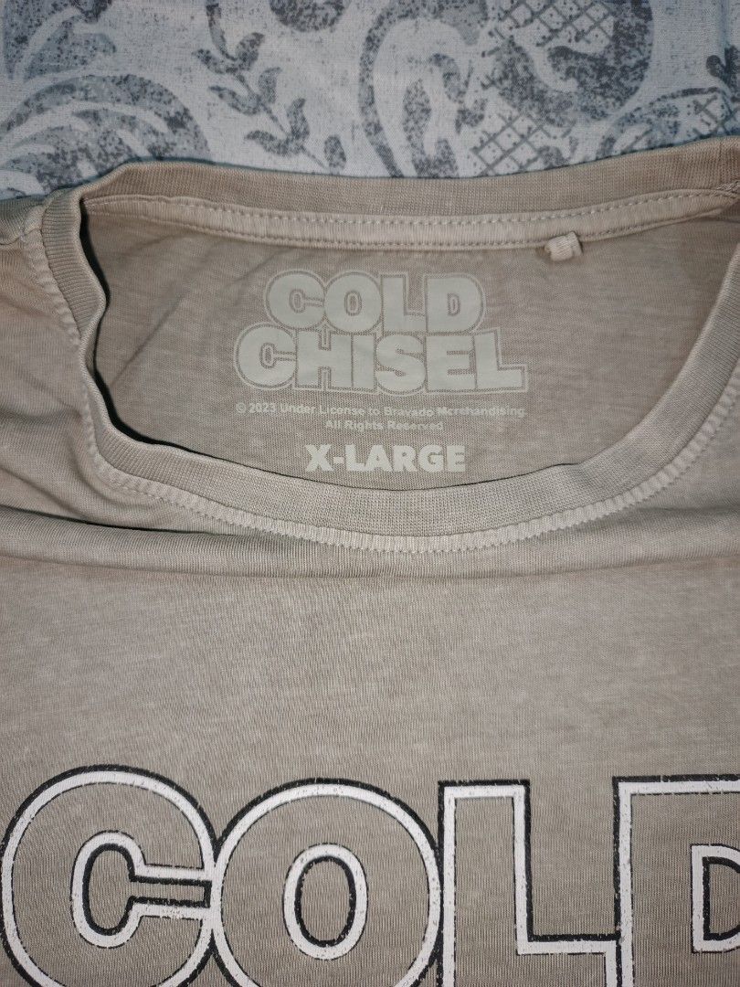 Cold Chisel Godzilla Graphic T-shirt - X-Large (Category: Tshirts & Polo Shirts ) located in Cavite. Submitted by henricoh (Listing ID 1429000068, Image 2). Description: Cold Chisel graphic t-shirt features a Godzilla design with the words "One Night Stand." It is an X-Large size. The shirt has a light brown color. The tag indicates it is from 2023. The shirt has a crew neck..