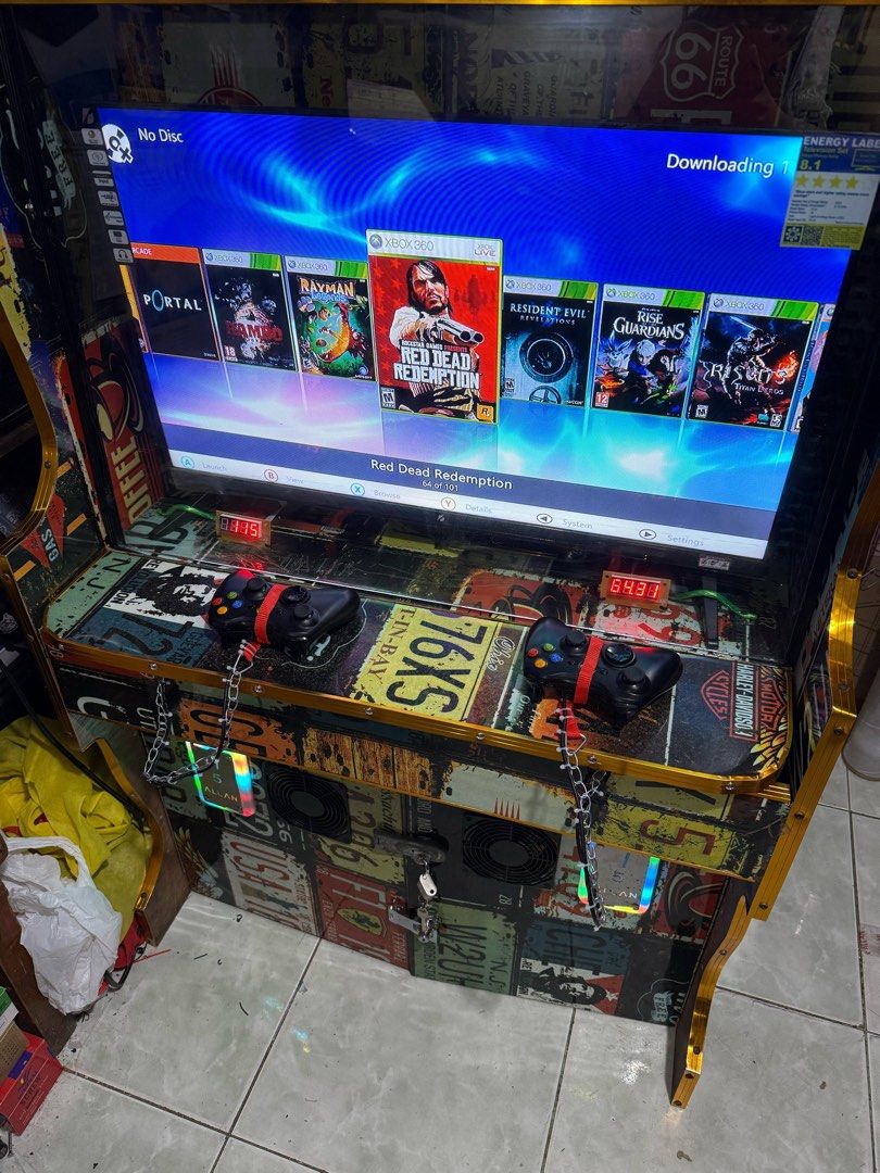 Custom Xbox 360 Arcade Machine (Category: Controllers) located in Makati City. Submitted by mr_palalay (Listing ID 1429098825, Image 1). Description: Custom-built arcade machine featuring an Xbox 360 console. Includes two controllers, a large screen, and a selection of pre-loaded games. The cabinet is decorated with a license plate design and has built-in cooling fans. Ready for hours of gaming fun!.