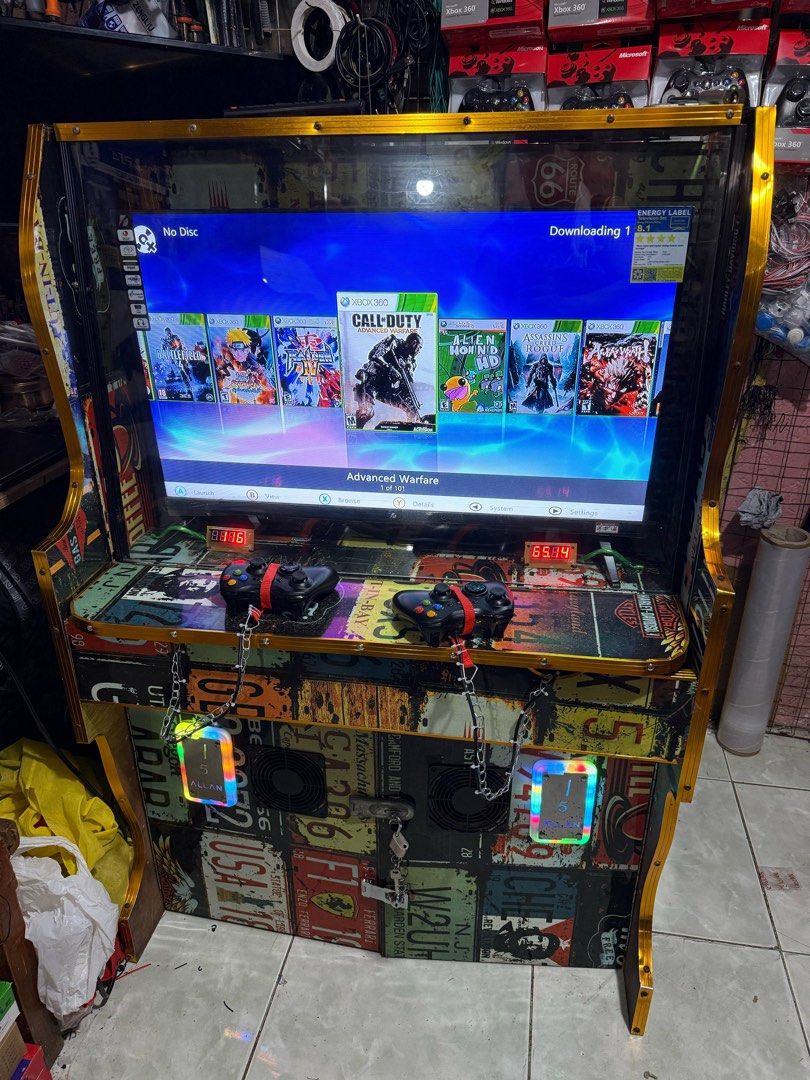 Custom Xbox 360 Arcade Machine (Category: Controllers) located in Makati City. Submitted by mr_palalay (Listing ID 1429098825, Image 2). Description: Custom-built arcade machine featuring an Xbox 360 console. Includes two controllers, a large screen, and a selection of pre-loaded games. The cabinet is decorated with a license plate design and has built-in cooling fans. Ready for hours of gaming fun!.