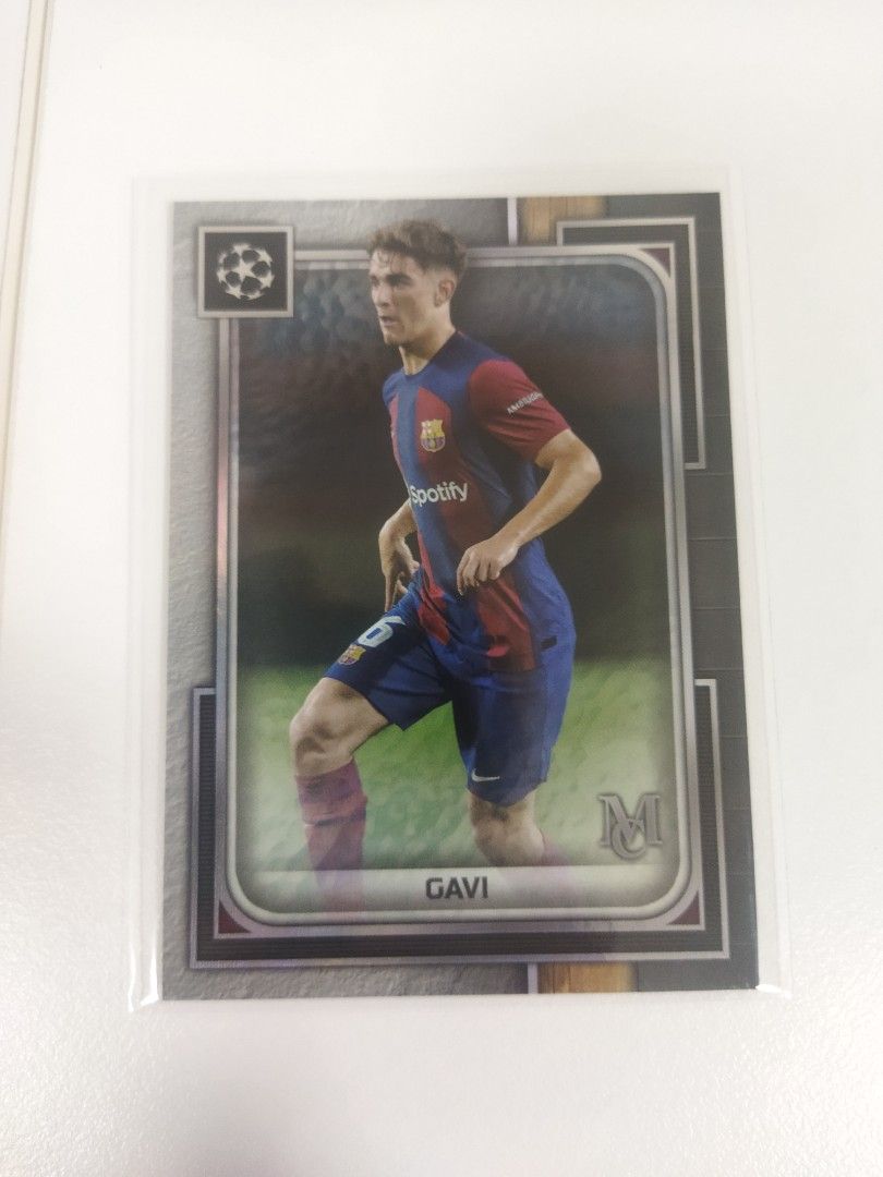 Gavi Football Thick Card (Category: Raw Singles) located in Pasay City. Submitted by 1988cdo (Listing ID 1429140716, Image 1). Description: Gavi football trading card. The card features Gavi in his Barcelona kit. The card is in a protective sleeve. The card has the Champions League logo on the top left corner and the letter "M" on the bottom right corner..