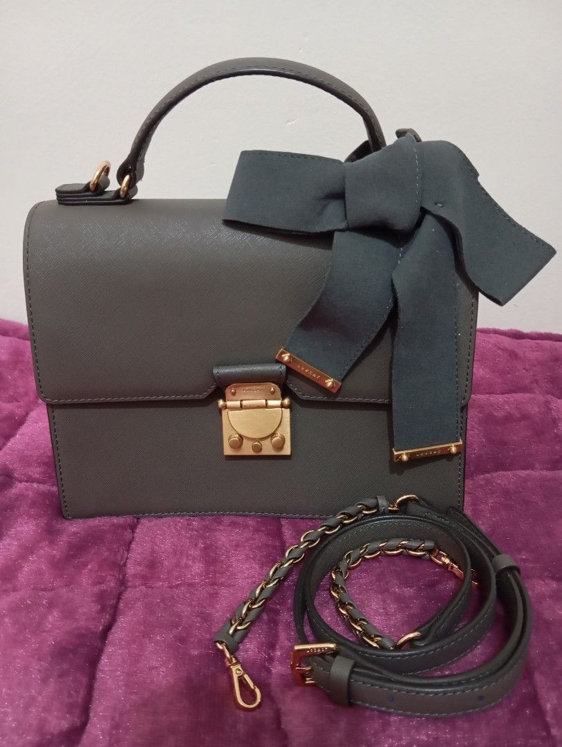 Grey Handbag with Bow Detail (Category: Luxury Bags & Wallets) located in Makati City. Submitted by bags_and_otherstuff (Listing ID 1429044195, Image 1). Description: Lovcat handbag with sling Saffiano leather Dark Gray Color South korea Bag barand.