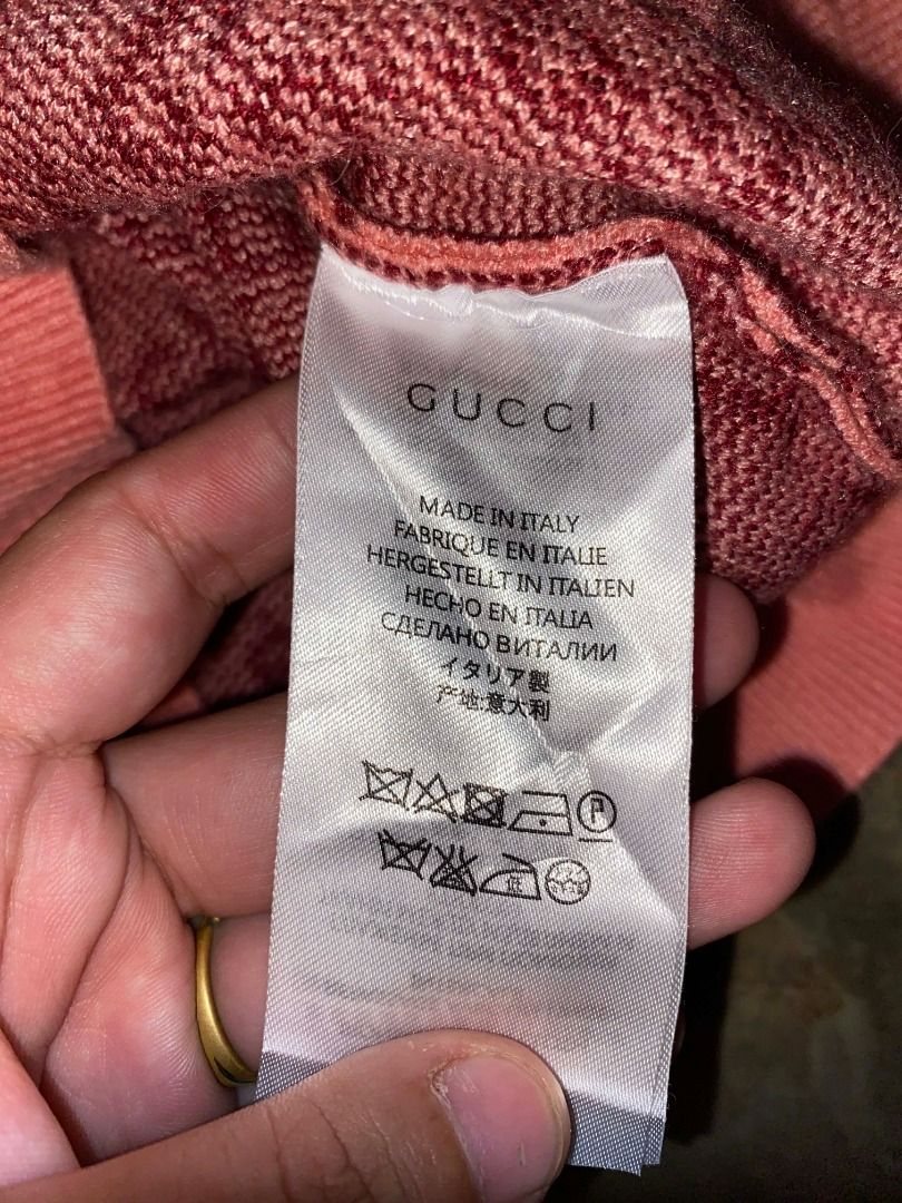 Gucci pink GG wool bouclé jacquard (Category: Luxury Apparel) located in Valencia. Submitted by jscurated (Listing ID 1429001084, Image 3). Description: Gucci short sleeve sweater. Features a pink base with the iconic Gucci logo pattern in a darker shade. Made in Italy. The sweater has a crew neck and short sleeves. The label indicates the brand and origin..