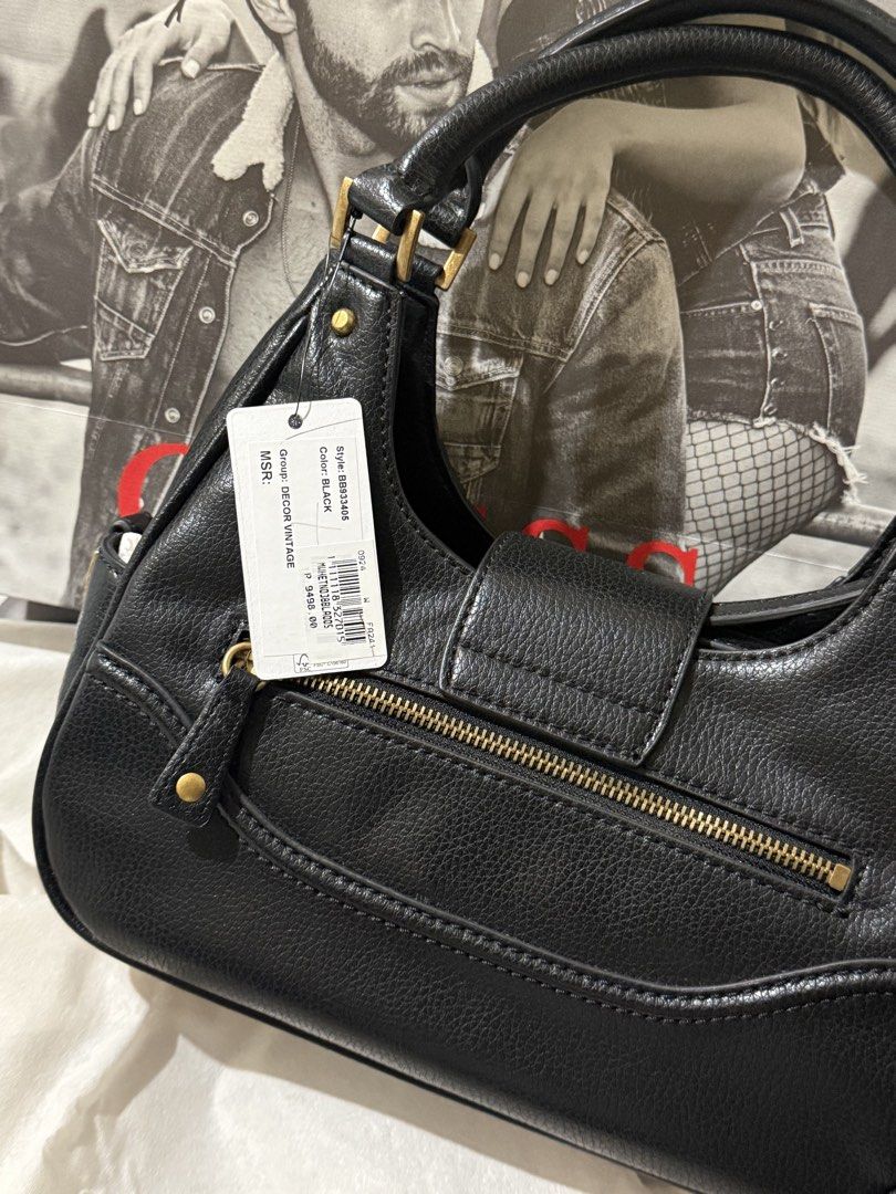 Guess Decor Vintage Black Handbag (Category: Luxury Bags & Wallets) located in Mandaluyong City. Submitted by Mshy09 (Listing ID 1429069209, Image 3). Description: Brandnew Original- Store bought at Robinsons Galleria Ortigas. Bagong bago naka plastic pa yung hardware sa sides. Original Price- P9498 -Includes it's original Paperbag and dustbag - Guess Handbag/cross bodybag - Gold-tone hardware - Magnet closure - Small side pocket - Detachable str