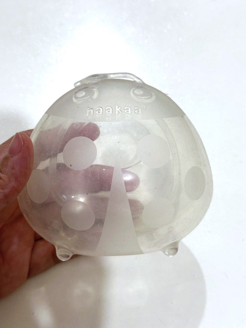 Haakaa Ladybug Silicone Milk Collector (Category: Breastfeeding & Bottle Feeding) located in Mandaluyong City. Submitted by ourcscloset (Listing ID 1429112629, Image 1). Description: Opened, used once then kept. Focused on hand expression and milk shells instead. No box to save space/ storage. Dusty because of storage.