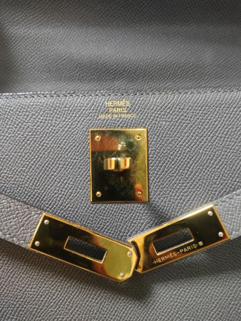 Hermès Kelly Handbag | 32 Grey (Category: Luxury Bags & Wallets) located in Quezon City. Submitted by justkeepdecluttering (Listing ID 1429130379, Image 2). Description: Elegant Hermès Kelly handbag in a beautiful grey color. Features a classic top handle design with a secure clasp closure. The bag has gold-toned hardware and protective feet on the bottom. A timeless piece for any wardrobe. Inclusions: - Box RFS: Declutter.