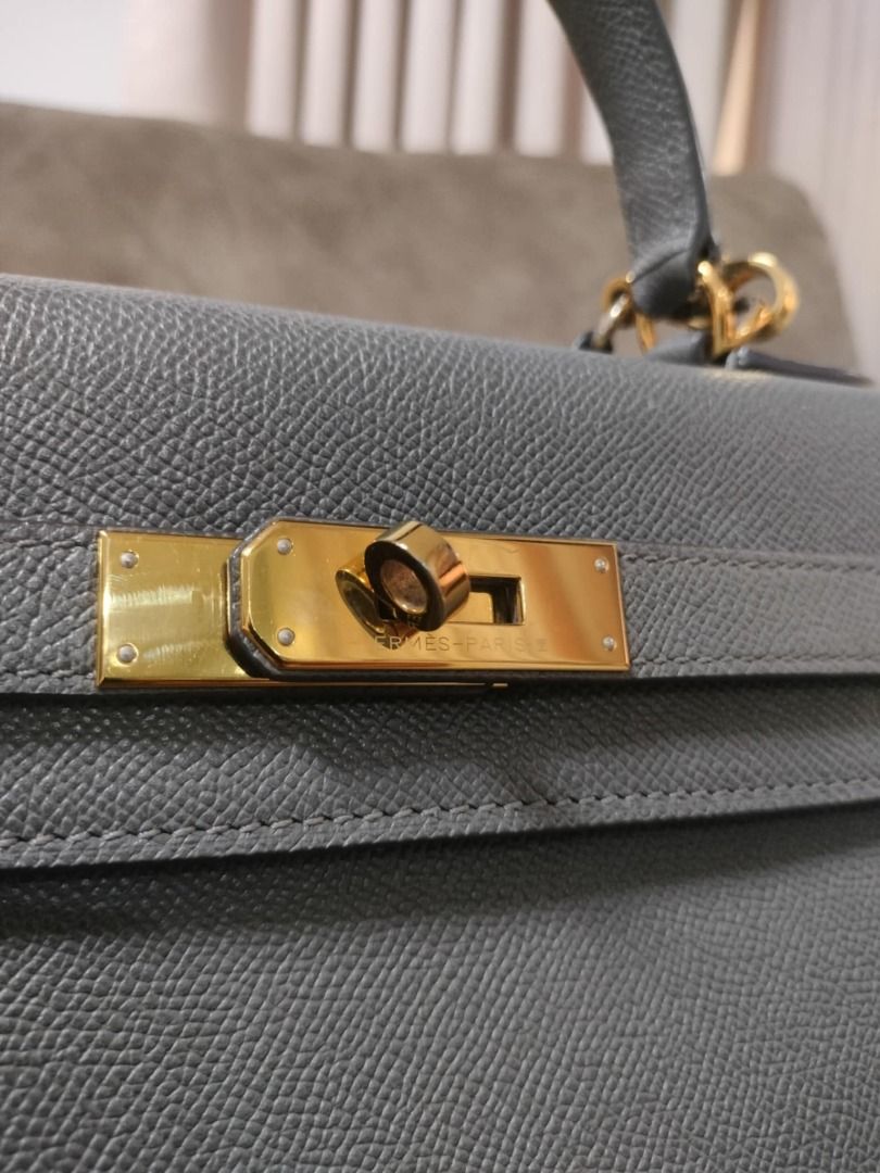 Hermès Kelly Handbag | 32 Grey (Category: Luxury Bags & Wallets) located in Quezon City. Submitted by justkeepdecluttering (Listing ID 1429130379, Image 3). Description: Elegant Hermès Kelly handbag in a beautiful grey color. Features a classic top handle design with a secure clasp closure. The bag has gold-toned hardware and protective feet on the bottom. A timeless piece for any wardrobe. Inclusions: - Box RFS: Declutter.