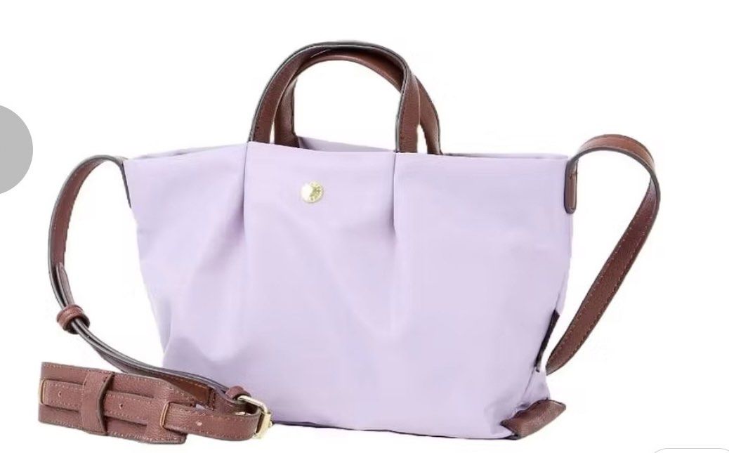 Legato Largo (Category: Luxury Bags & Wallets) located in Batangas. Submitted by aveena0413 (Listing ID 1429099816, Image 1). Description: Brand: Legato Largo Model: LH-L0005 Kataraku (Water-Repellent Nylon Mini Shoulder) Color: Lavender (Japan Design) Condition: Brand new, bought in Japan Features: • Water-repellent nylon — good for light rain and everyday use ￼ • Compact yet practical — fits essentials like phone, wallet, keys, and small access
