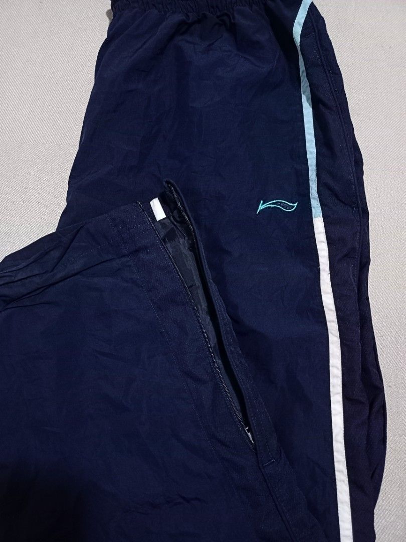 Li-Ning Track Pants in Navy Blue (Category: Joggers) located in Quezon City. Submitted by ri_yaaa (Listing ID 1429098460, Image 3). Description: ‼️PLEASE READ BEFORE BUYING ‼️ This is a pre-loved item. The color of the product may vary due to lighting. RFS: • Decluttering • Size XL on tag (W27-30 L40) • Navy Blue • Garterized w/ drawstring • Embroidered Li-Ning logo • Ankle zip (both working) • Condition 9/10 • Color rate 10/10 • Issue: No aglets