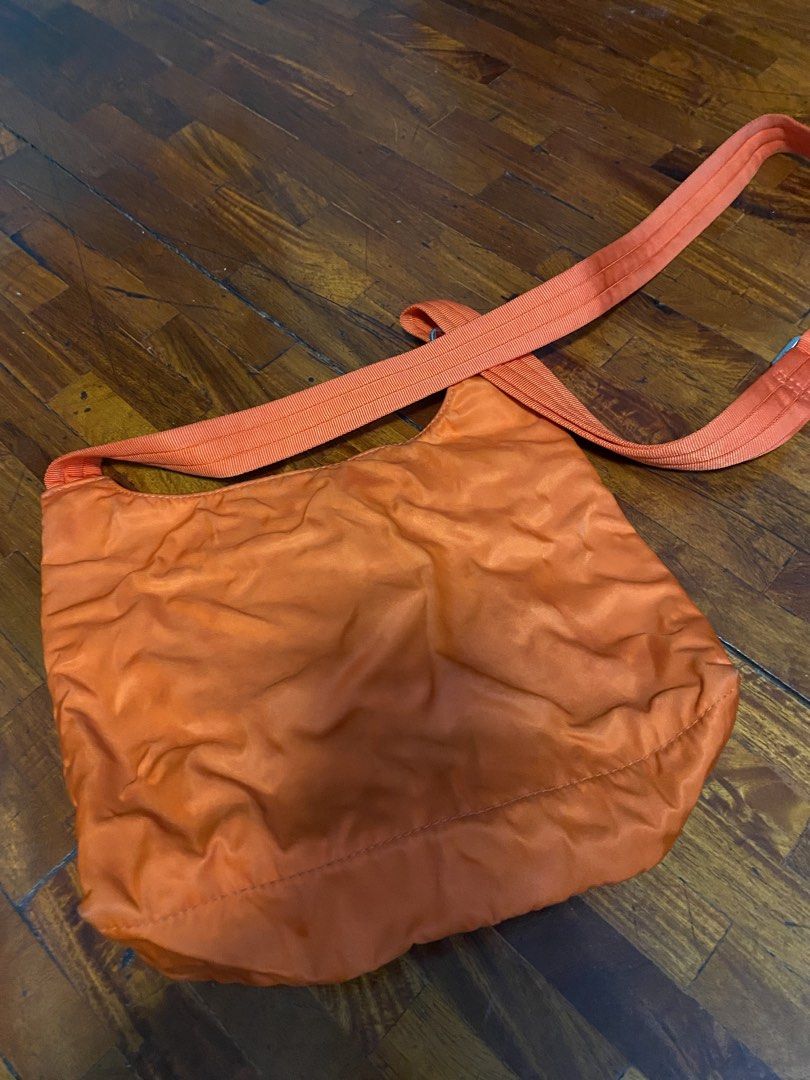 Longchamp Orange Messenger Bag (Category: Luxury Bags & Wallets) located in Pasig City. Submitted by pjw888 (Listing ID 1429123098, Image 3). Description: Orange Longchamp messenger bag. Features a zippered main compartment and an adjustable shoulder strap. The bag has a Longchamp logo patch inside. The bag has a front zippered pocket. Issue: Wrinkled.