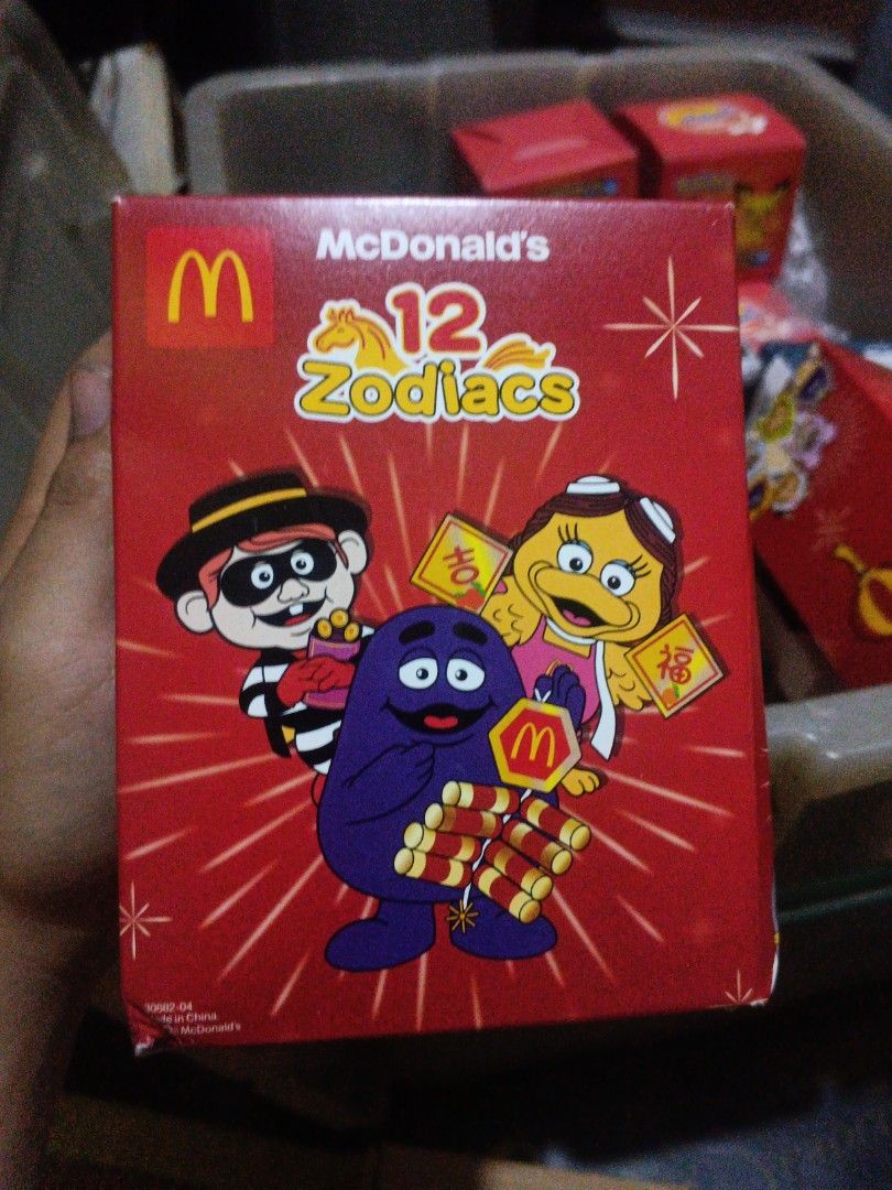 McDonald's 12 Zodiacs Monkey Box (Category: Character Goods) located in Manila. Submitted by dailyhomiescollection (Listing ID 1429024843, Image 1). Description: THE BOX WAS A LITTLE DENT BUT IT WAS STILL NEW McDonald's 12 Zodiacs collectible box featuring the Monkey design. The box is red and has the McDonald's logo. The front of the box shows various cartoon characters. The side of the box has a monkey character. The box is likely from a promot
