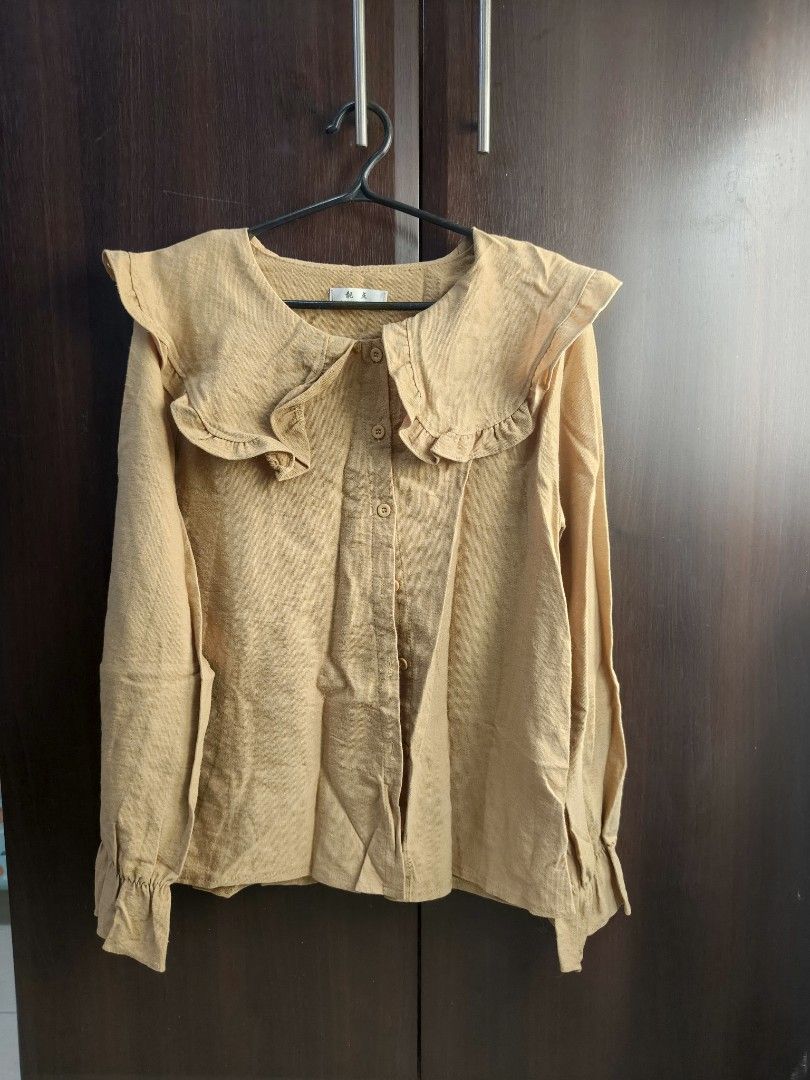 Mustard Yellow Ruffle Collar Blouse (Category: Blouses) located in Taguig. Submitted by declutterwithhannie (Listing ID 1429161404, Image 1). Description: Mustard yellow blouse with a unique ruffle collar design. Features long sleeves with buttoned cuffs and a button-down front..