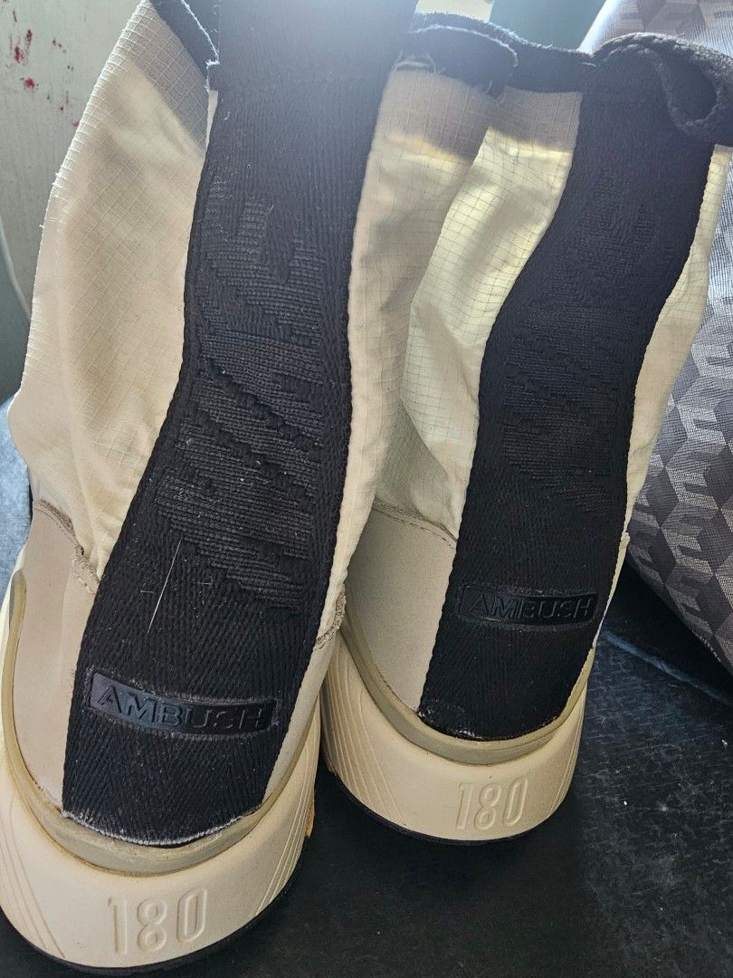Nike Air Max 180 High Top Sneakers (Category: Sneakers) located in Mandaluyong City. Submitted by bethco (Listing ID 1429034751, Image 2). Description: Nike Air Max 180 high-top sneakers. Features a zip-up design with a white and black color scheme. The sole has a visible Air Max unit. The size is 10.5. The shoes have a unique design with a mix of materials. The soles show some wear. free shipping via j&t visible stains.