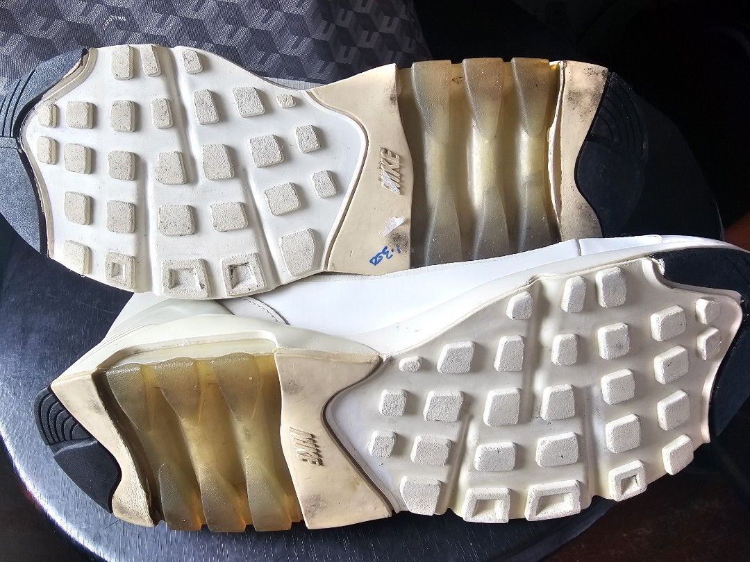 Nike Air Max 180 High Top Sneakers (Category: Sneakers) located in Mandaluyong City. Submitted by bethco (Listing ID 1429034751, Image 3). Description: Nike Air Max 180 high-top sneakers. Features a zip-up design with a white and black color scheme. The sole has a visible Air Max unit. The size is 10.5. The shoes have a unique design with a mix of materials. The soles show some wear. free shipping via j&t visible stains.