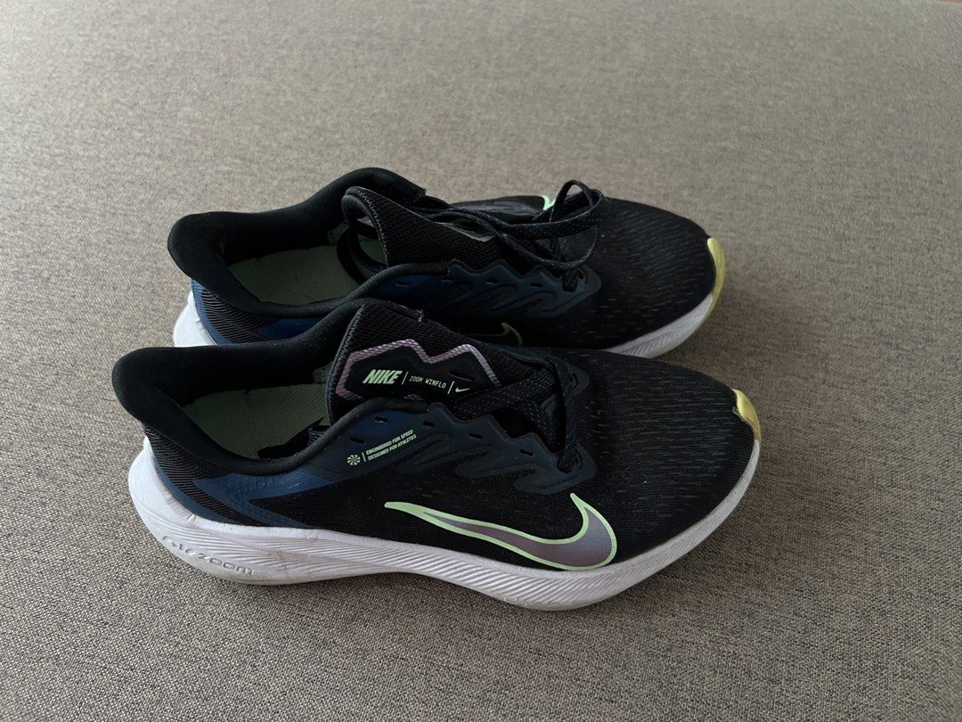 Nike Women Shoes (Category: Sneakers) located in Iloilo. Submitted by jfindsss2 (Listing ID 1428993364, Image 1). Description: 800 Each Pm for more info ALL AUTHENTIC These Nike running shoes feature a black and white design with the Nike swoosh logo. The images show two different models: Zoom Winflo and Quest. The Zoom Winflo model has a teal accent on the tongue and the Quest model has a pink accent. Both models have a white sole..