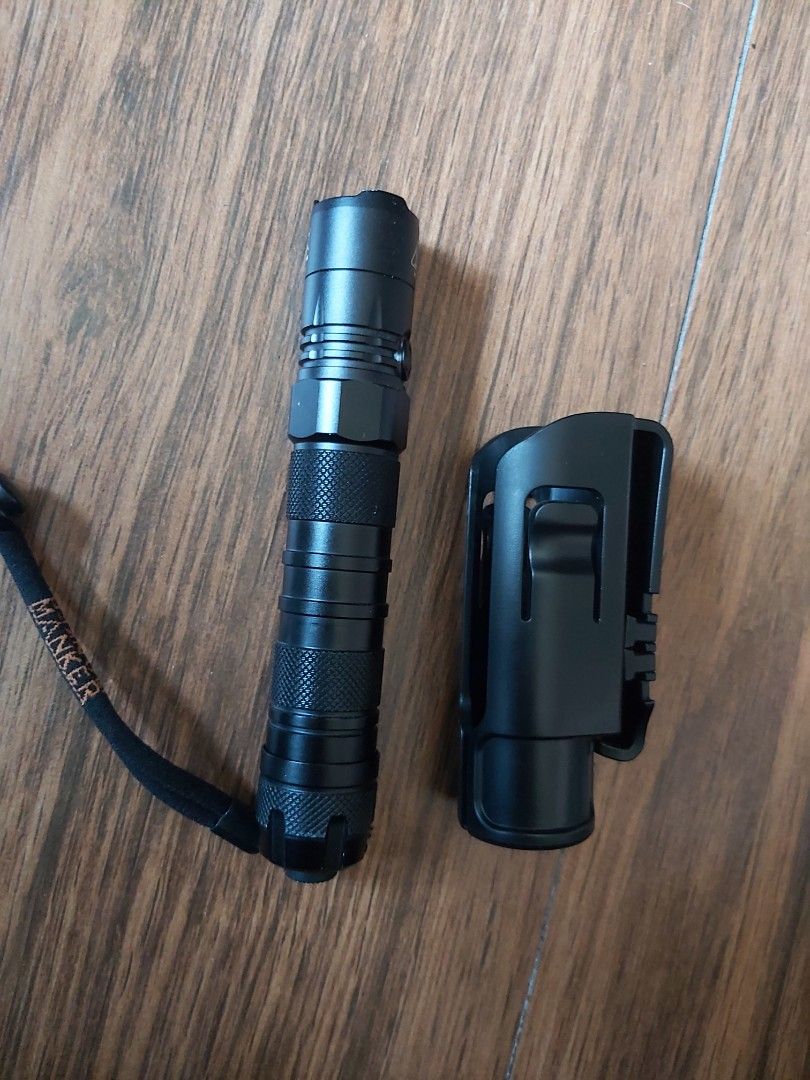 Nitecore New P12 Flashlight with Holster (Category: Lighting) located in Mandaluyong City. Submitted by j.alonso (Listing ID 1429031865, Image 2). Description: Manker New P12 flashlight is a compact and powerful lighting tool. It features a textured grip for secure handling and comes with a holster for easy carrying. It includes a lanyard for added convenience. The design suggests durability and reliability for various applications. Like New with