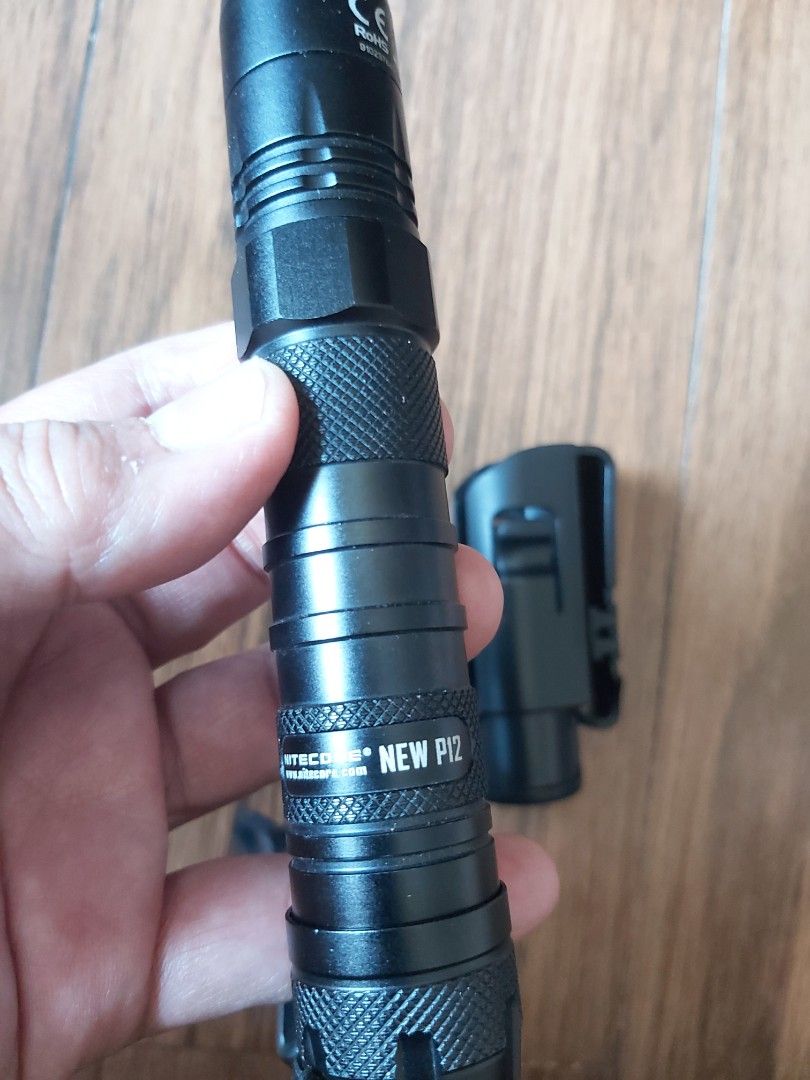 Nitecore New P12 Flashlight with Holster (Category: Lighting) located in Mandaluyong City. Submitted by j.alonso (Listing ID 1429031865, Image 1). Description: Manker New P12 flashlight is a compact and powerful lighting tool. It features a textured grip for secure handling and comes with a holster for easy carrying. It includes a lanyard for added convenience. The design suggests durability and reliability for various applications. Like New with