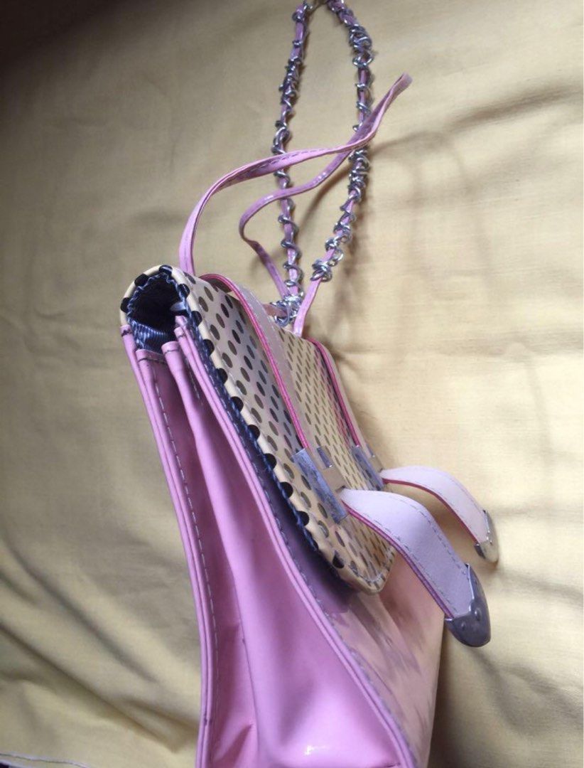 Pink and Yellow Handbag with Chain Strap (Category: Shoulder Bags) located in Mandaluyong City. Submitted by jennyitems (Listing ID 1429161627, Image 3). Description: 👜 Stylish handbag featuring a unique design with a chain strap. 🎀 The bag has a pink exterior with a yellow and black dotted pattern on the front. 🎀 It includes a main compartment with a zipper pocket and a magnetic closure. 🎀 The bag also has a pink interior lining and a detach