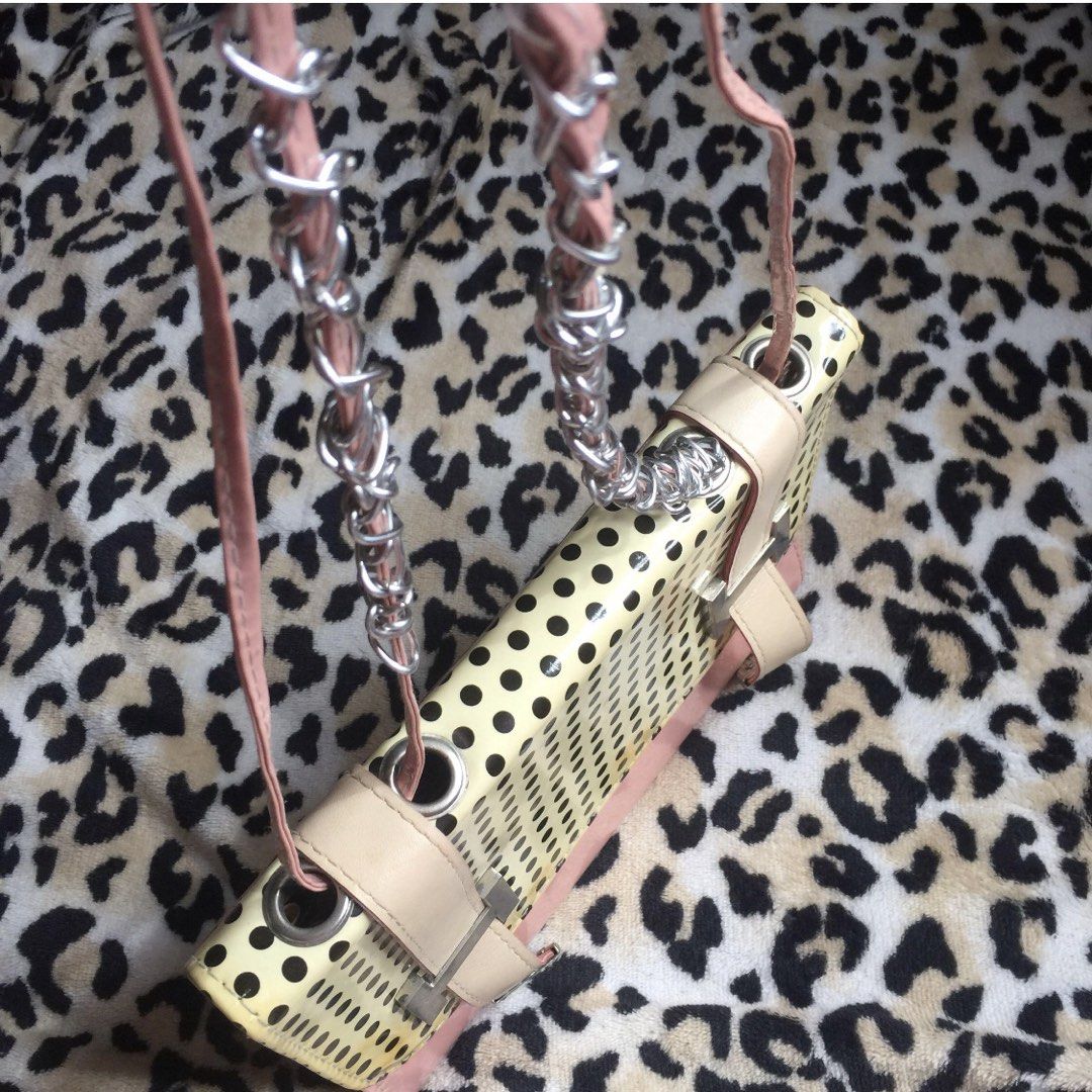 Pink and Yellow Handbag with Chain Strap (Category: Shoulder Bags) located in Mandaluyong City. Submitted by jennyitems (Listing ID 1429161627, Image 1). Description: 👜 Stylish handbag featuring a unique design with a chain strap. 🎀 The bag has a pink exterior with a yellow and black dotted pattern on the front. 🎀 It includes a main compartment with a zipper pocket and a magnetic closure. 🎀 The bag also has a pink interior lining and a detach