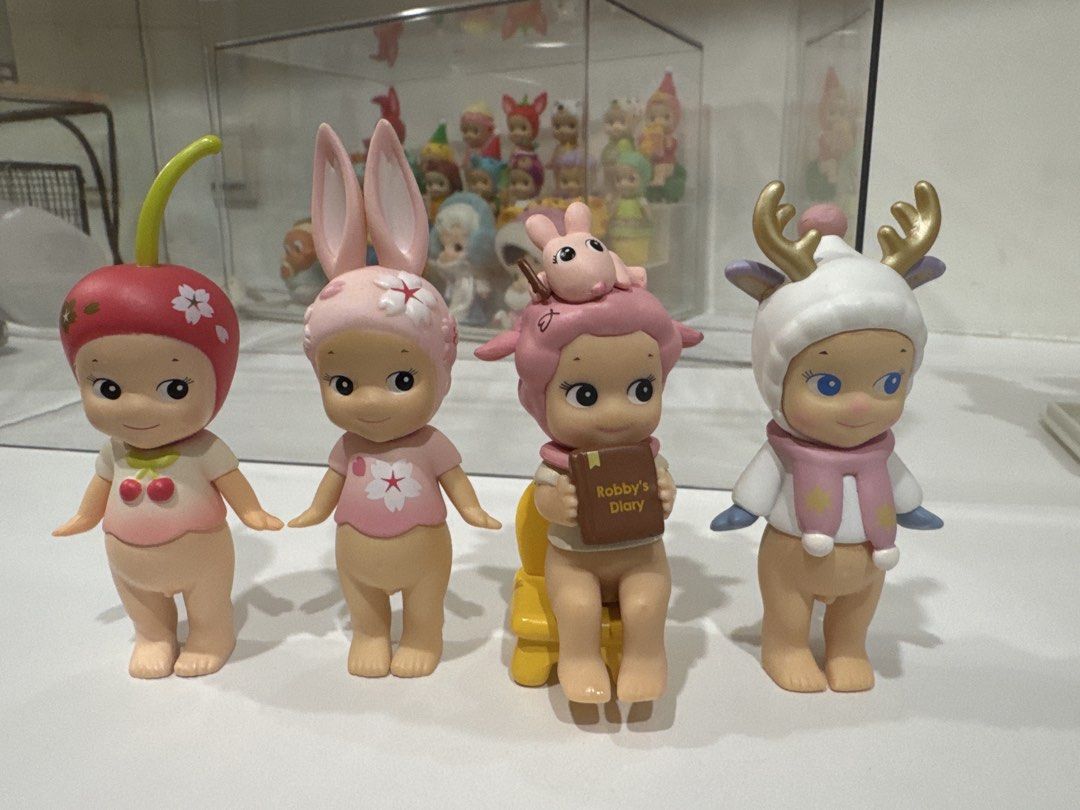 Sonny Angel Mini Figures - Cherry, Bunny, Sheep, Deer (Category: Designer & Blind Box Toys) located in Singapore. Submitted by kianatann (Listing ID 1429096501, Image 1). Description: DUPES. Sonny angels for sale, selling my collection. I was told it was real when I bought it then got scammed that it was fake 🥲but the seller was really nice and these dupes are actually really good quality! 1. Apple Sakura $10 2. Pink Sakura $10 3. Robby’s diary 