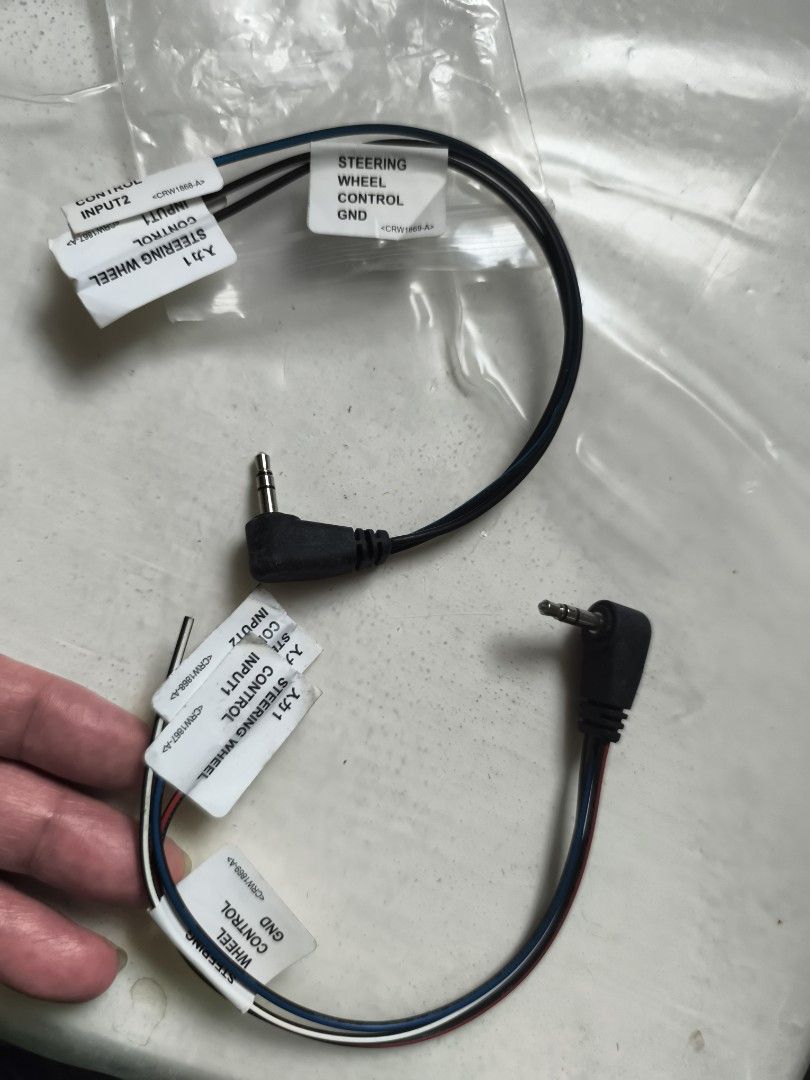 Steering Wheel Control Cable 2pcs (Category: Cables & Adaptors) located in Cavite. Submitted by Combiishop (Listing ID 1428991504, Image 2). Description: Steering wheel control cable with 3.5mm jack. It has labels for "INPUTS", "STEERING WHEEL CONTROL", and "GND". The cable is black with white, blue, and red wires..