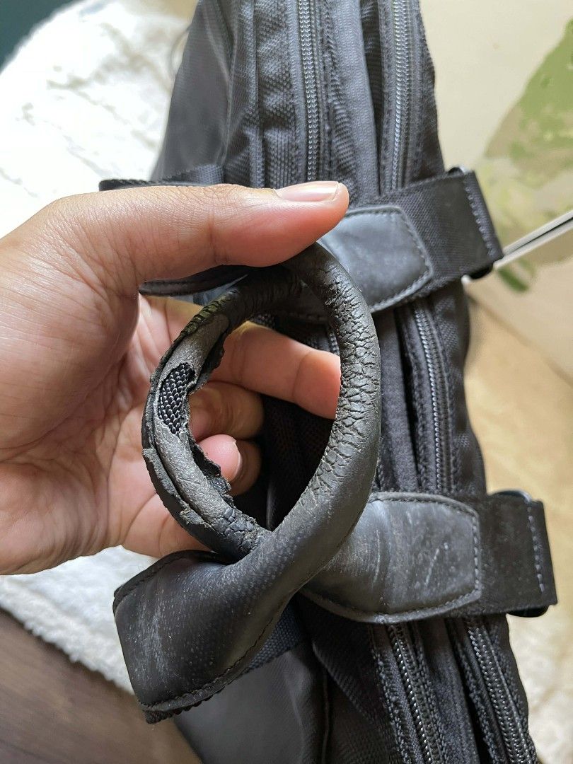 Tumi Black Briefcase laptop bag (Category: Briefcases) located in Naawan. Submitted by twillycalledprelovedbags (Listing ID 1429014732, Image 3). Description: issue: handle, sign of use Black Tumi briefcase with two front pockets. Features a top handle and a detachable tag. The interior is lined with gray fabric. The bag measures approximately 15 inches in width and 12 inches in height..