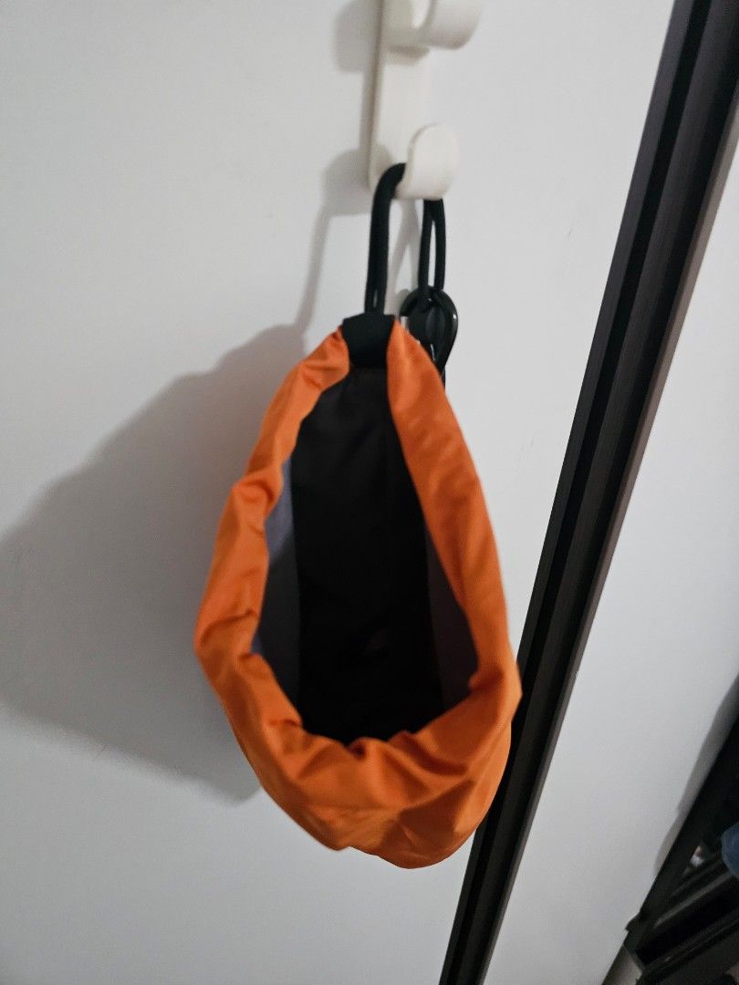 Uniqlo Beach Orange Sling Bag (Category: Cross-body Bags) located in Las Pinas. Submitted by specteretceps (Listing ID 1429064007, Image 2). Description: Sling bag features a vibrant orange exterior with a black zipper and strap. The interior is black. It has a drawstring closure and a compact design, perfect for carrying essentials. It's a simple, functional bag for everyday use..