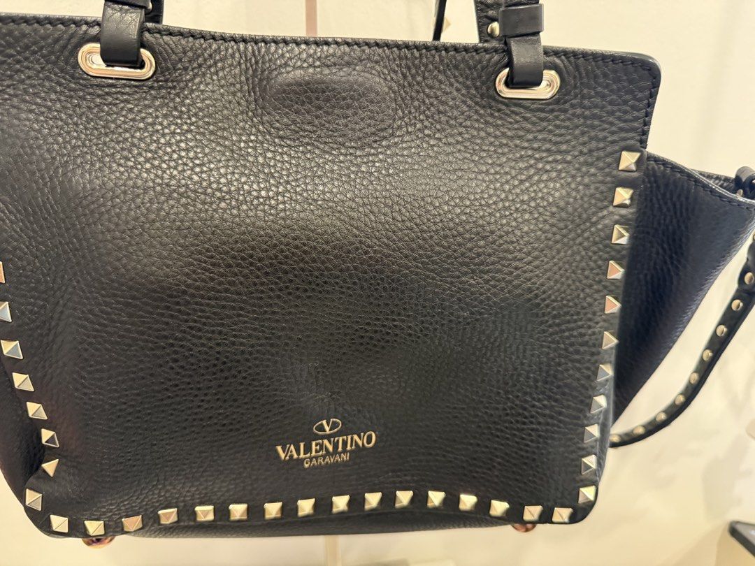 Valentino Garavani Rockstud Tote Bag (Category: Luxury Bags & Wallets) located in Pasay City. Submitted by wanabruce820 (Listing ID 1429054455, Image 3). Description: RFS: decluttering Complete Studs with Sling Provided dust bag only Bought in Osaka Japan Small size shoulder bag Black Preloved .