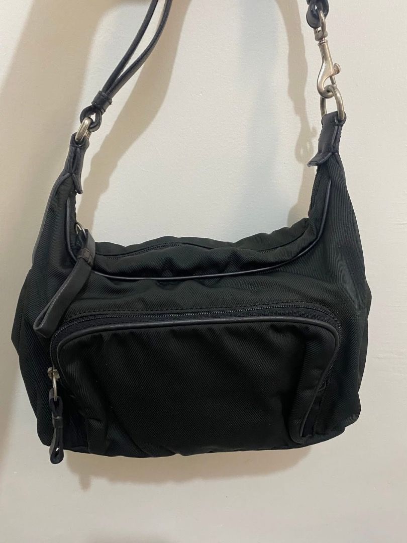 Vintage Coach Black Shoulder Bag nylon (Category: Luxury Bags & Wallets) located in Paete. Submitted by ladder_leynn (Listing ID 1429148743, Image 2). Description: Black shoulder bag with a front zippered pocket. Features a top handle and a detachable shoulder strap. The bag has a silver-tone hardware. The bag has a simple design, suitable for everyday use..