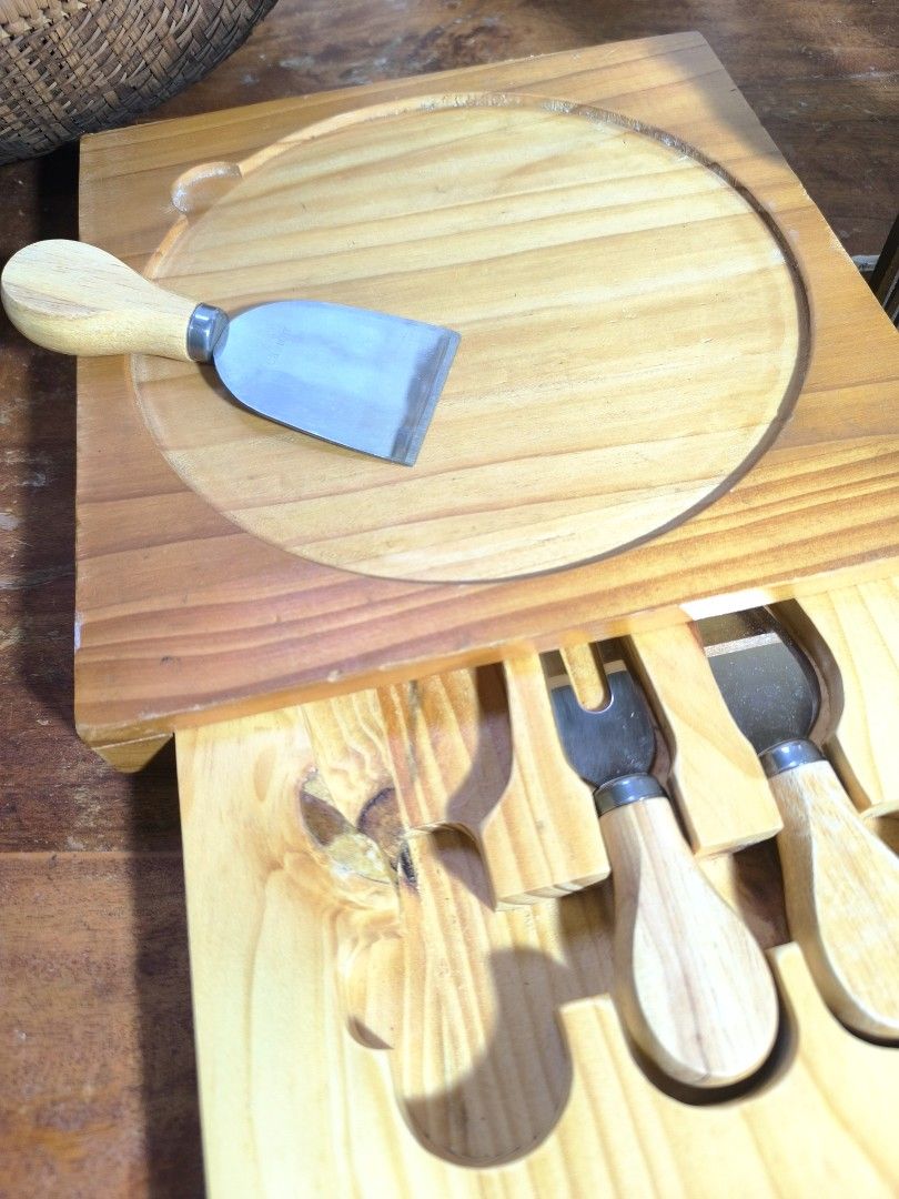 Wooden Cheese Board Set with Knives (Category: Knives & Chopping Boards) located in Pangil. Submitted by kopee_matcha (Listing ID 1429075881, Image 2). Description: Cheese board set includes a wooden board with a circular inset and a drawer containing three cheese knives. The knives have wooden handles and stainless steel blades. The board is square-shaped with a natural wood finish..