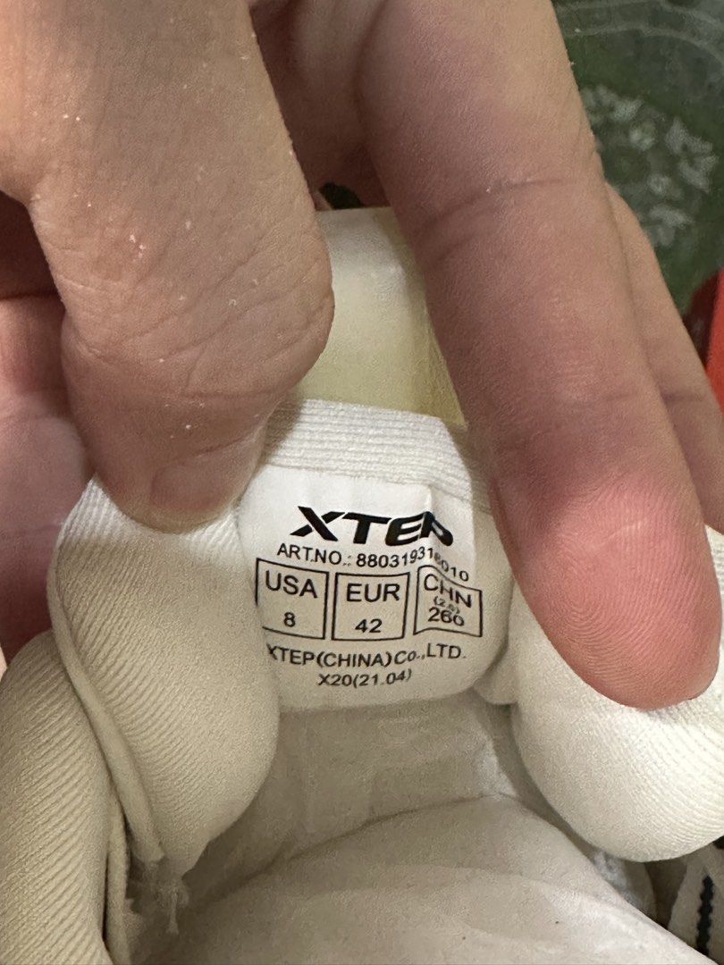 Xtep White Sneakers - Size 8 (Category: Sneakers) located in Rodriguez. Submitted by mnl_premium_essentials (Listing ID 1429147739, Image 3). Description: White Xtep sneakers. Features a lace-up design with black and white laces. The shoes have a padded collar and tongue. The size is indicated as US 8, EUR 42, and CHN 266. The shoes come with the original box..
