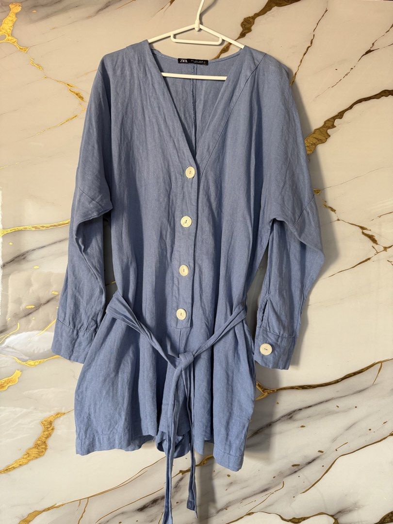 ZARA Blue Romper with Belt (Category: Rompers) located in Marikina City. Submitted by declutter_keni24 (Listing ID 1429053198, Image 1). Description: Hey there! 👋 Check out this super cute ZARA blue romper! It's a size L, perfect for a comfy yet stylish look. This romper comes with a matching belt to cinch your waist and has a flattering V-neck design. 😉.