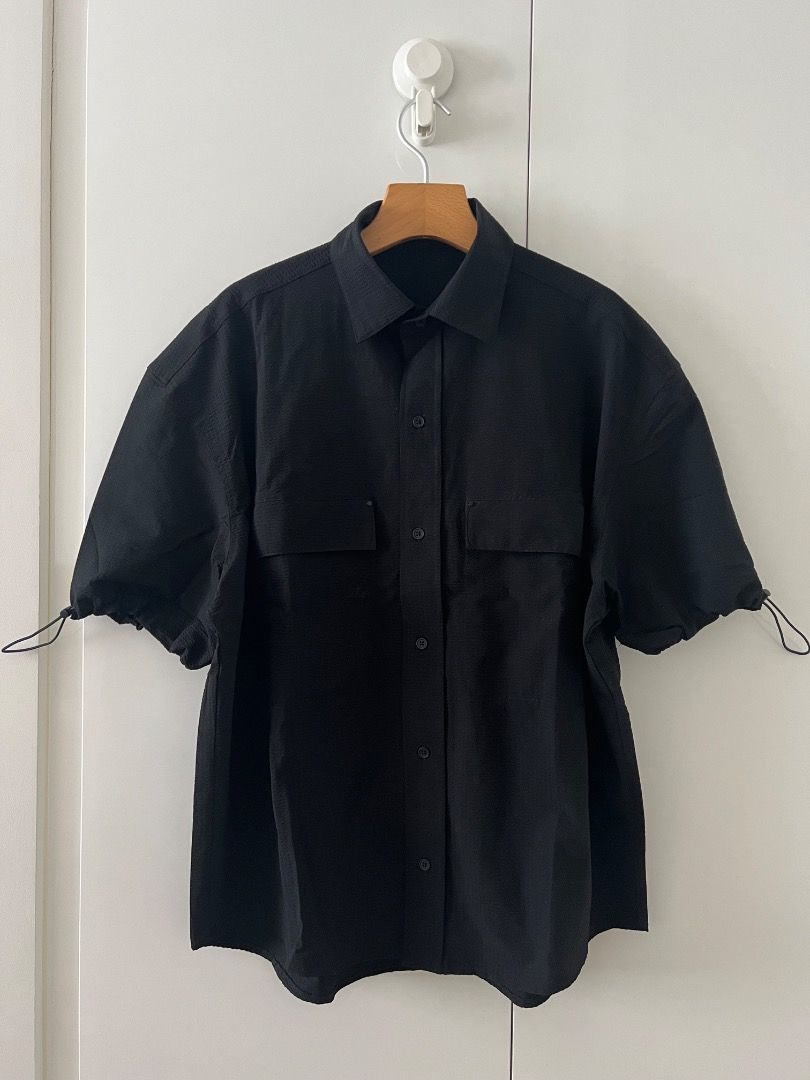 Zara Black Shirt with adjustable sleeve hems (Category: Formal Shirts) located in Quezon City. Submitted by shphlc25 (Listing ID 1428991727, Image 2). Description: Black shirt, oversized fit with adjustable sleeve opening 88% polyamide (nylon) 12% elastane Seersucker fabric structure (may crinkle effect) Front chest pockets with metal rivets Buttoned center front placket Curved hem Regular collar Sleeve hems with elastic draw cord and stoppers to