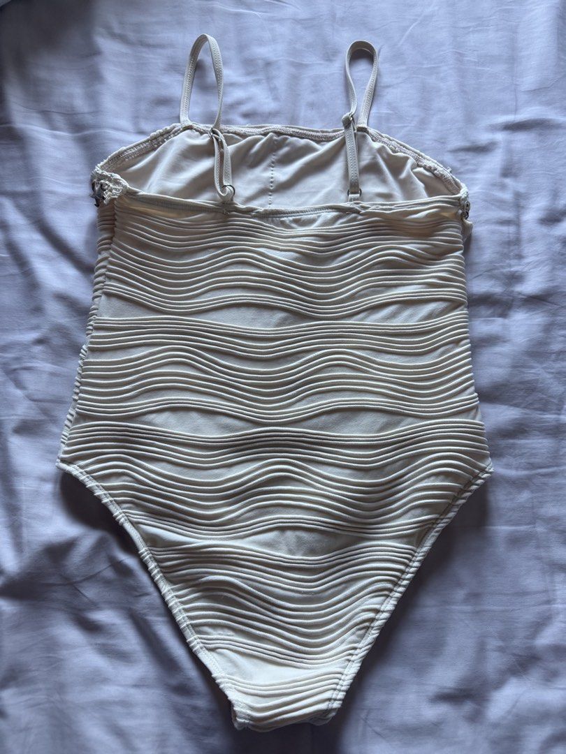 10Y Cream-colored Wave Textured Swimsuit (Category: Babies & Kids Fashion) located in Taguig. Submitted by macncheese (Listing ID 1424519947, Image 3). Description: - Cream-colored one-piece swimsuit - Features wave-like texture - Adorned with seashell and starfish charms - Adjustable straps - Size: 10 - Shein - Used once.