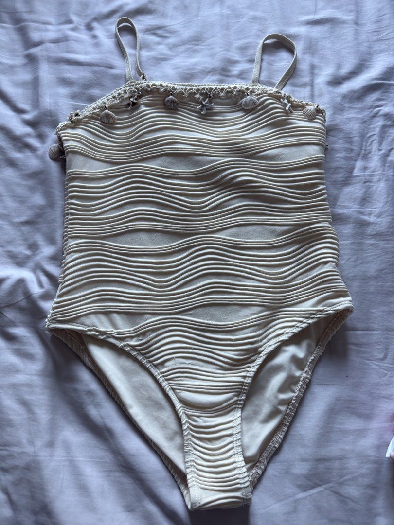10Y Cream-colored Wave Textured Swimsuit (Category: Babies & Kids Fashion) located in Taguig. Submitted by macncheese (Listing ID 1424519947, Image 1). Description: - Cream-colored one-piece swimsuit - Features wave-like texture - Adorned with seashell and starfish charms - Adjustable straps - Size: 10 - Shein - Used once.