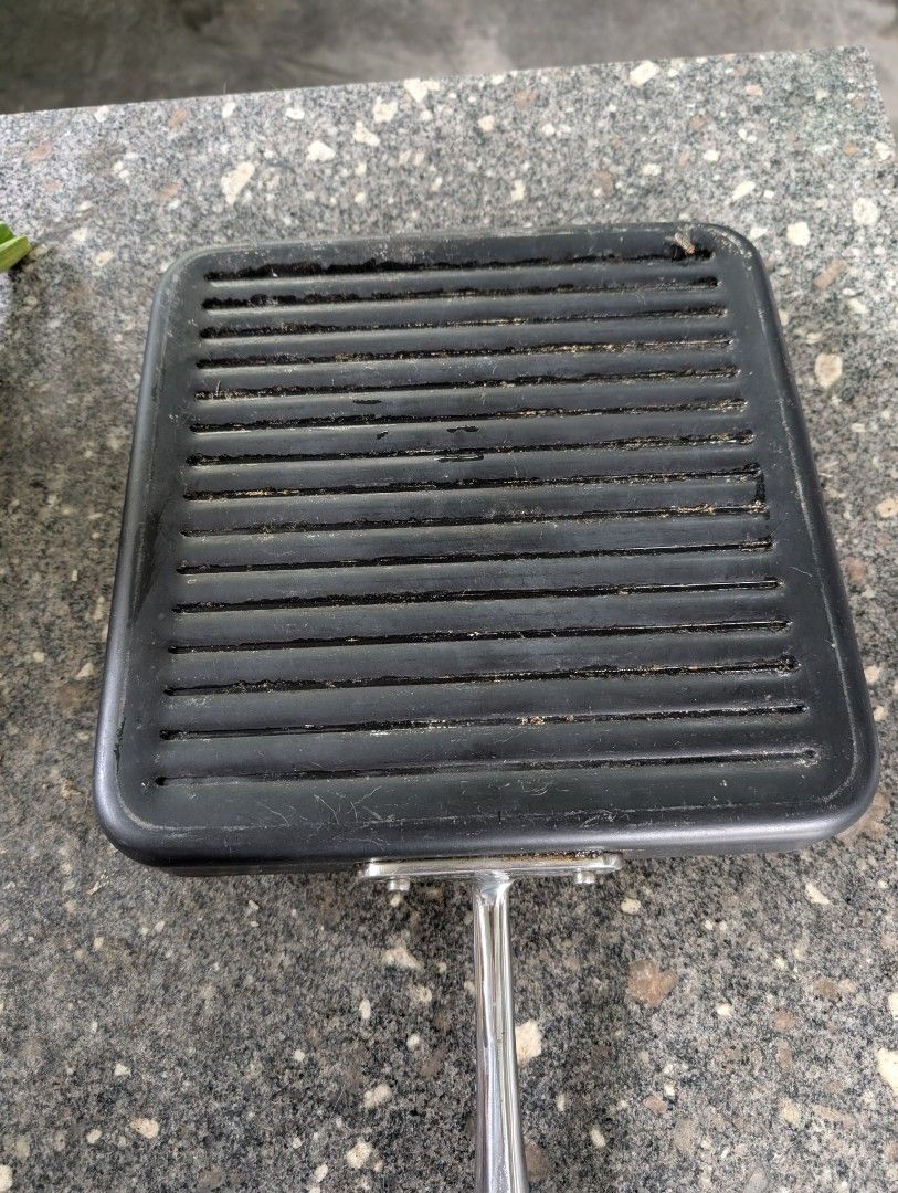 All-Clad Square Grill Pan (Category: Cookware & Accessories) located in Midsayap. Submitted by Pandabearstore (Listing ID 1424377163, Image 3). Description: - All-Clad square grill pan - Ridged cooking surface - Long handle for easy handling - Durable dark metal construction - Ideal for grilling.