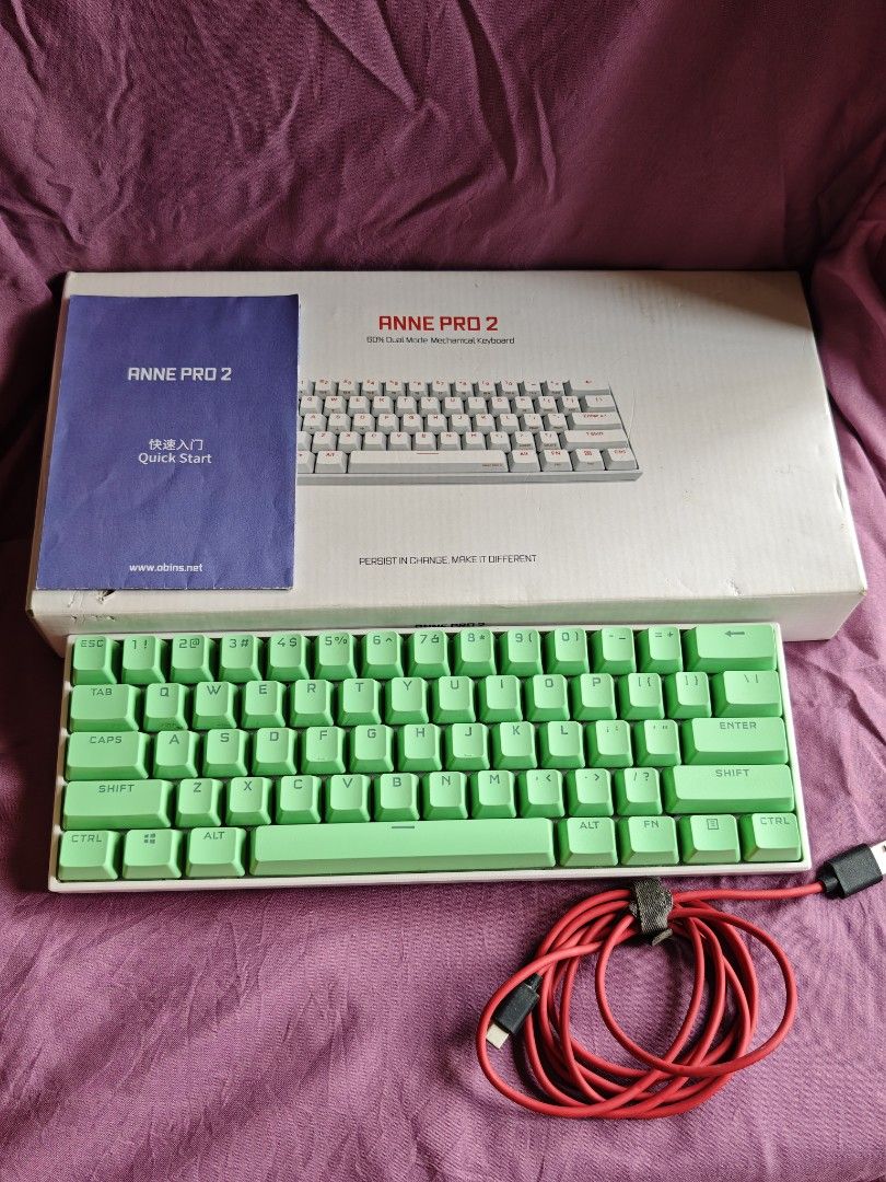Anne Pro 2 60% Mechanical Keyboard (Category: Computer Keyboard) located in Quezon City. Submitted by farsiren06 (Listing ID 1424495174, Image 2). Description: - Anne Pro 2 60% mechanical keyboard - Green keycaps - White frame - Includes original box - Includes quick start guide - Includes red USB-C cable -With yellow stains sa gilid..